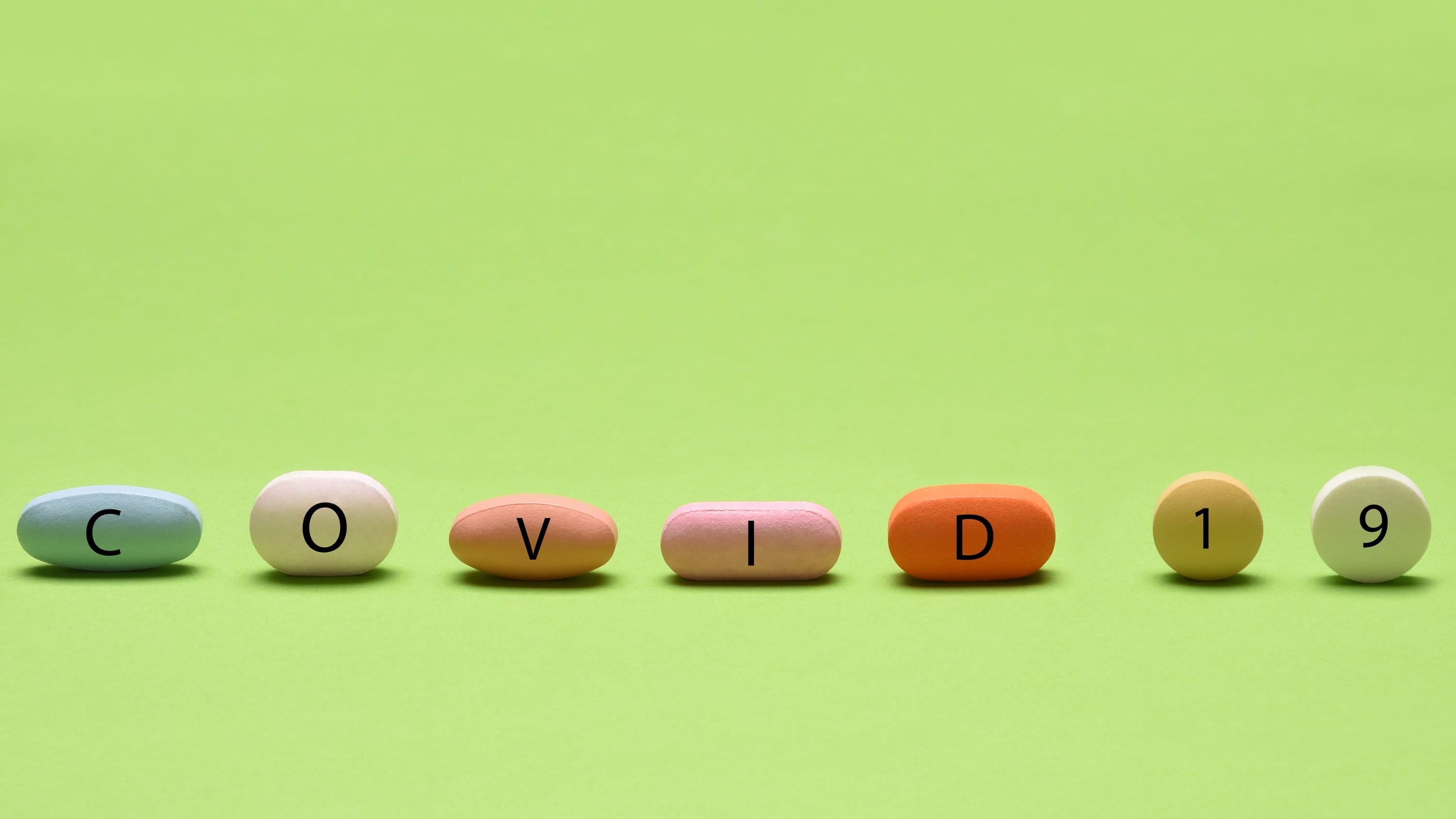 pills spelling covid, representing COVID-19 treatments