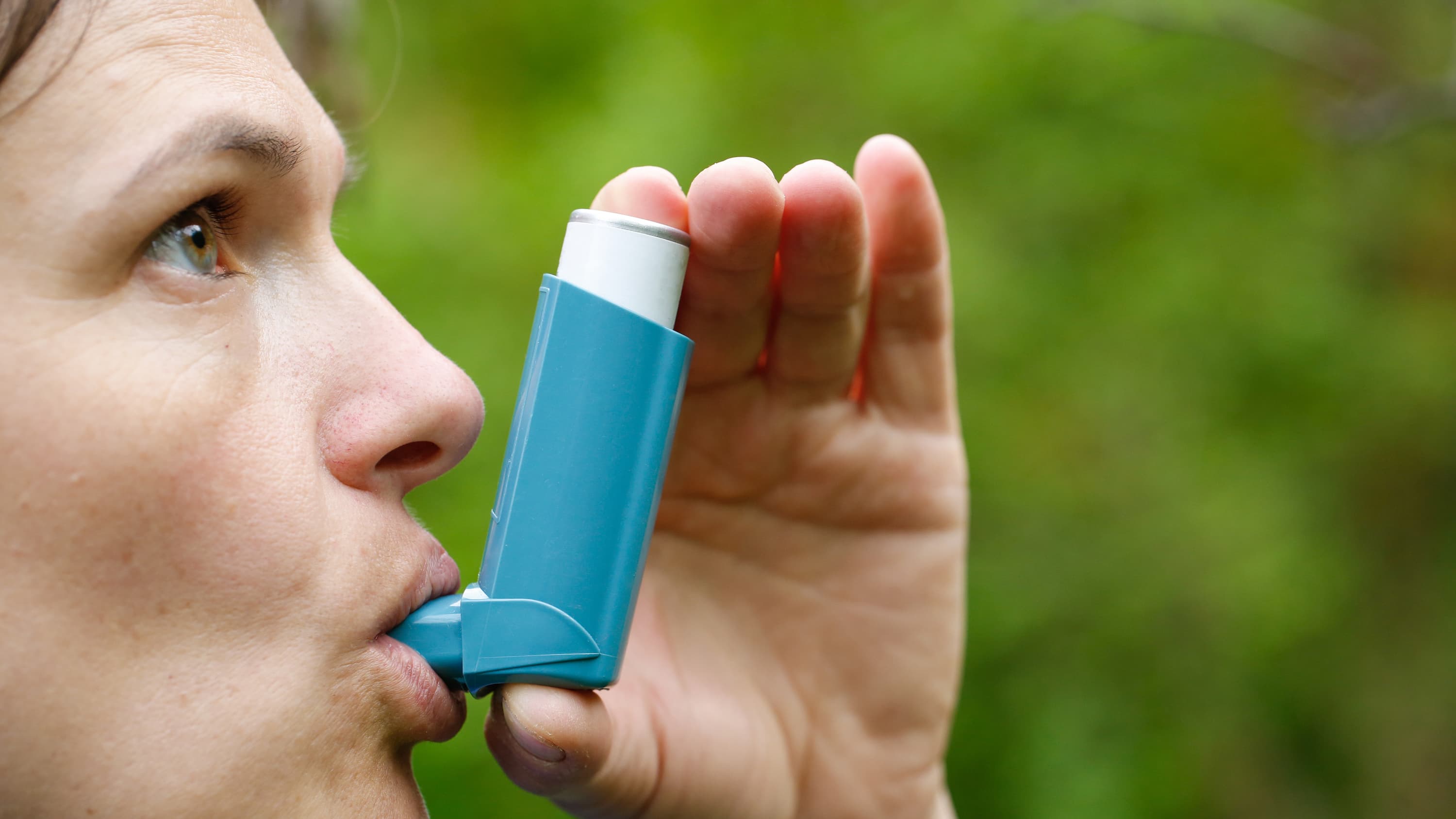A woman with chronic obstructive pulmonary disease is using a blue inhaler.