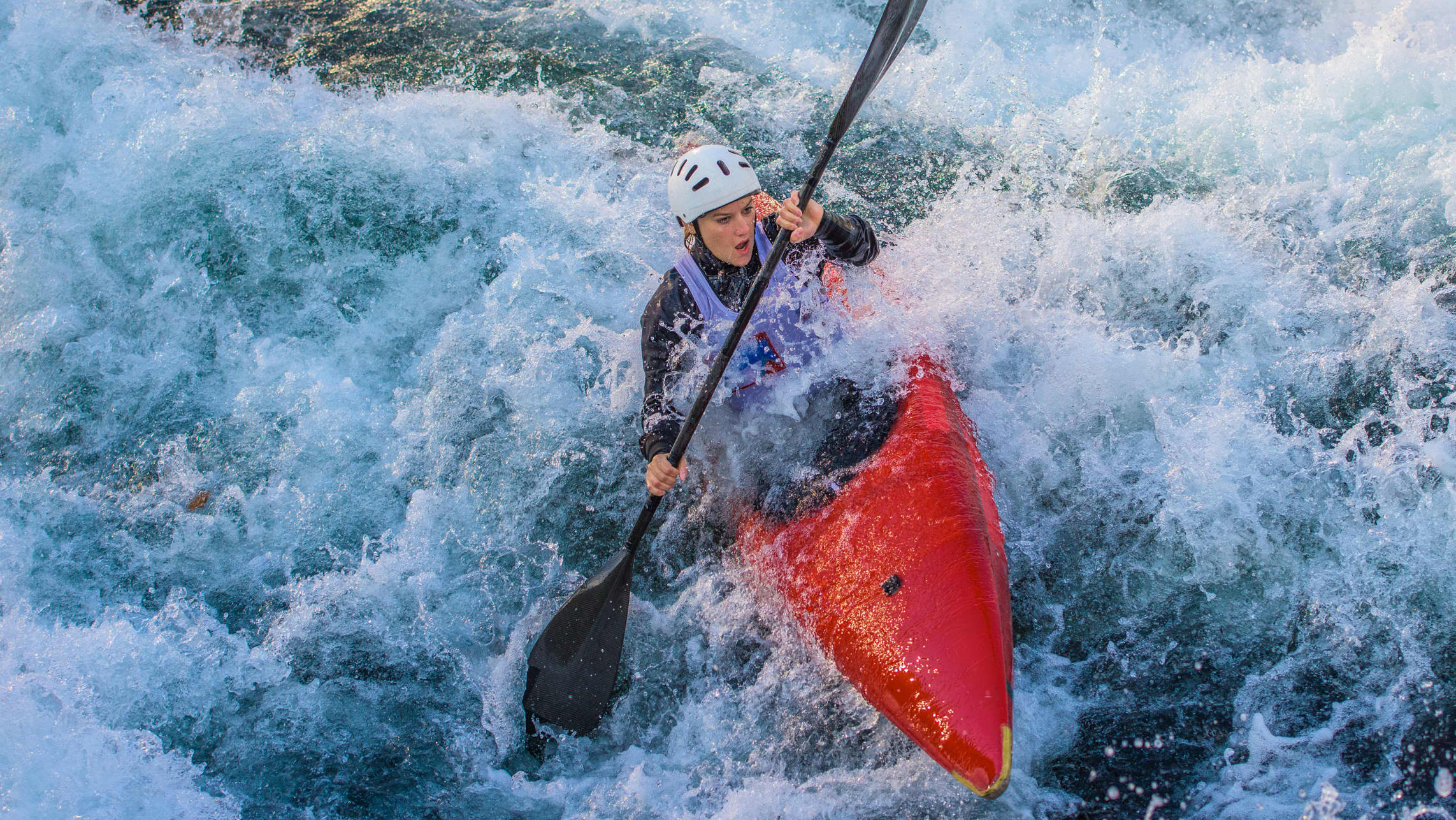 A kayaker braves white waves, hopefully avoiding an outdoor emergency or injury