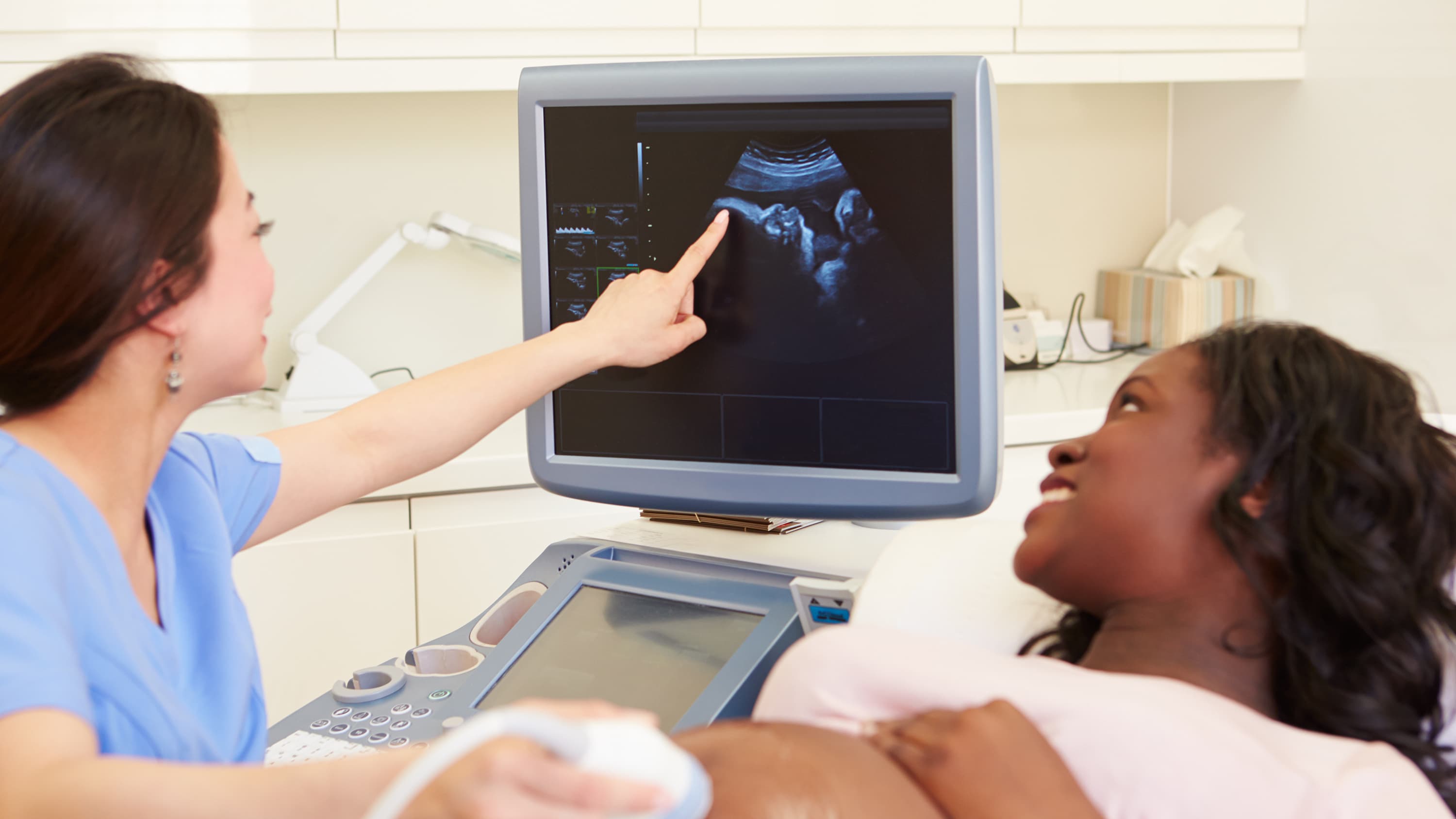 A mother receives an ultrasound, one way to check for some congenital heart defects.
