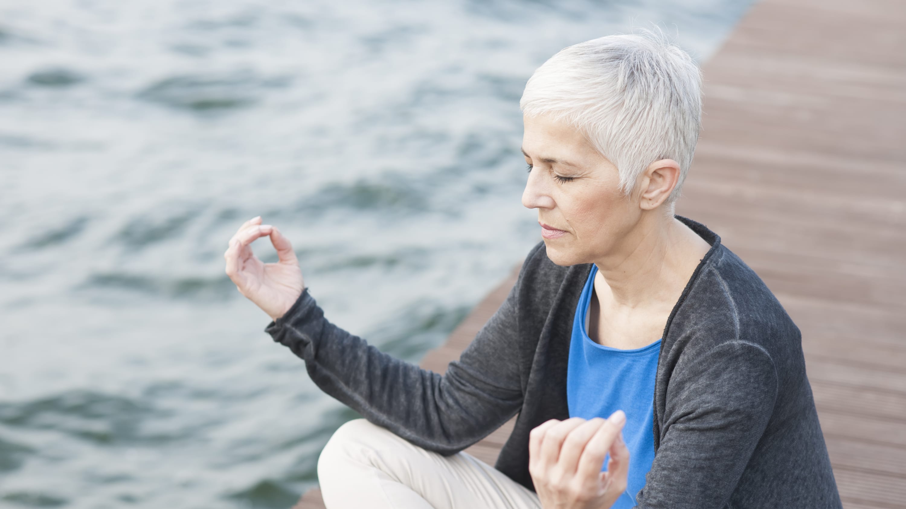 A woman with chronic pain practices yoga.