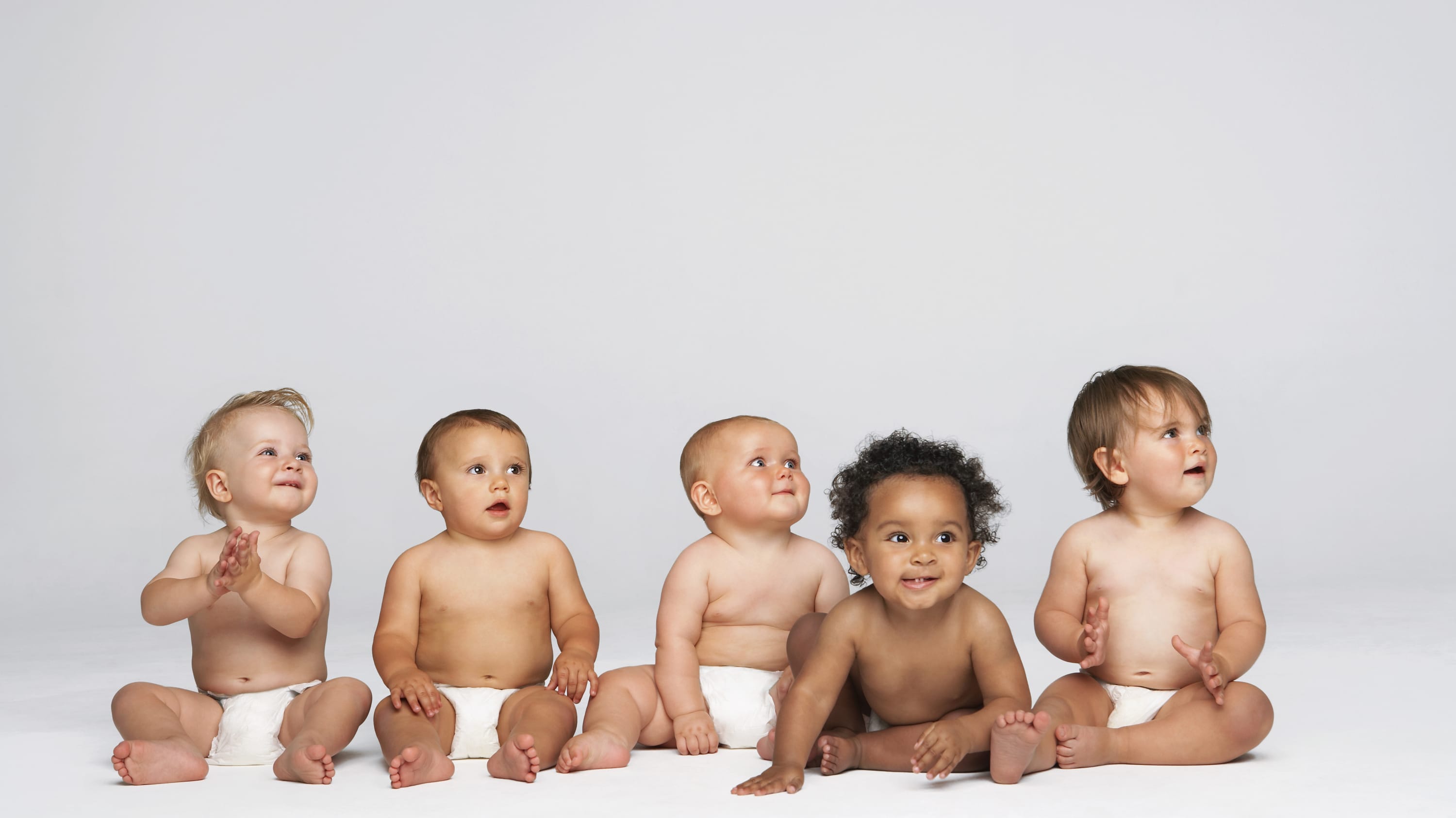 A group of babies, possibly born as the result of IVF, a successful infertility treatment