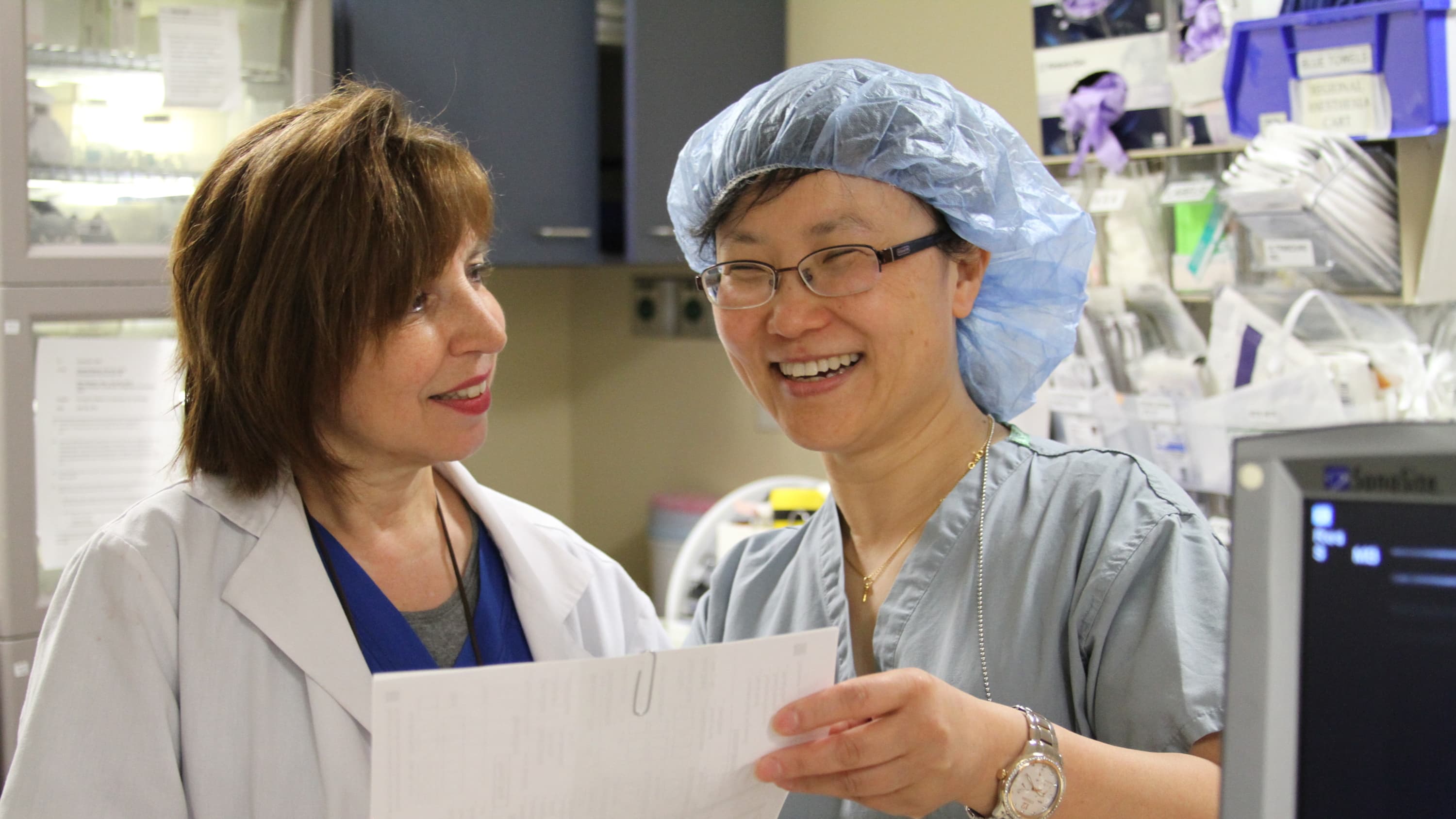 Nerve block nurse Lisa Mastrangello (on the left) with Jinlei Li, MD, an anesthesiologist, discussing a nerve block, which is a type of regional anesthesia.