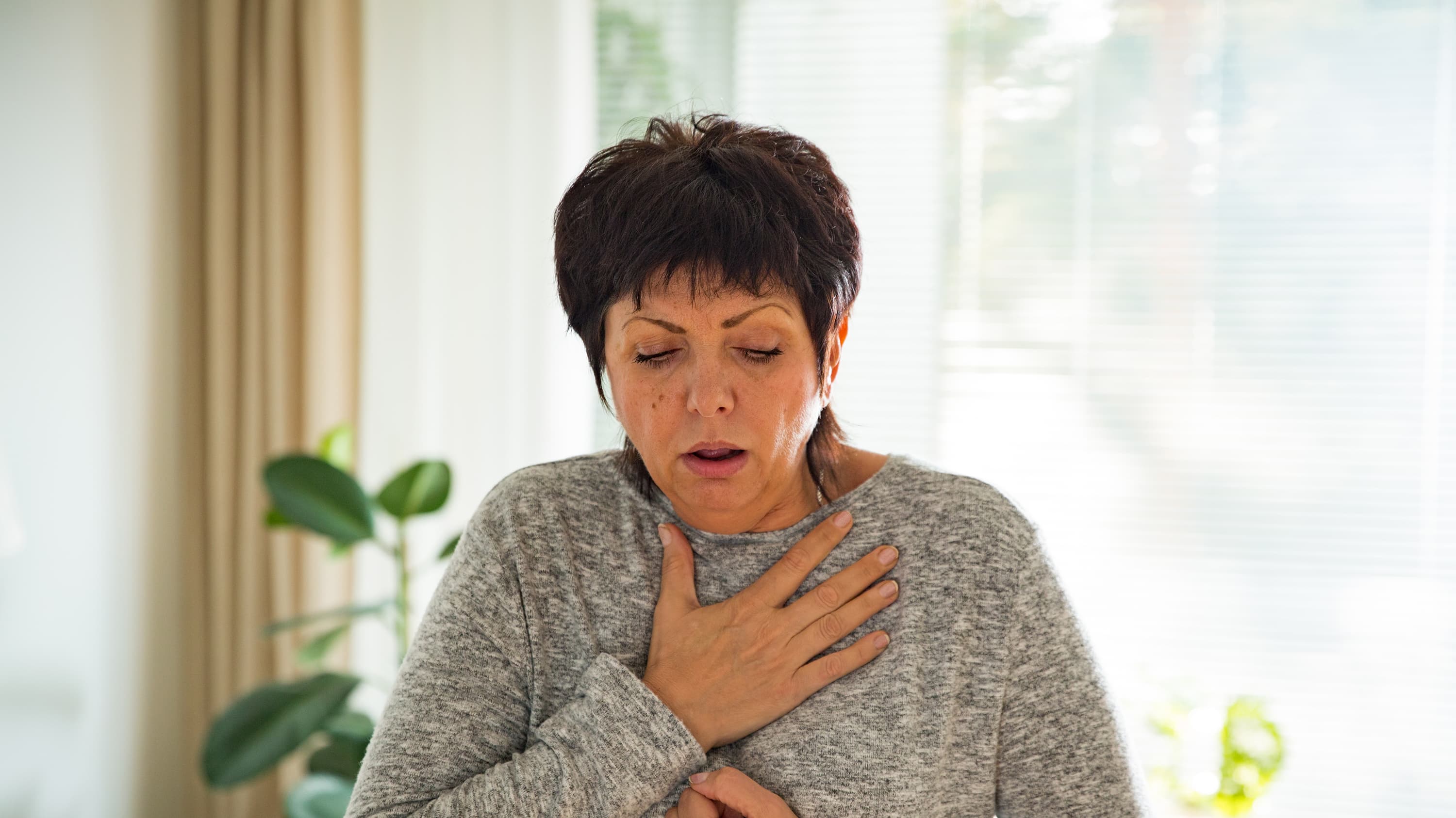 A woman suffering with dypnea struggling to breath.