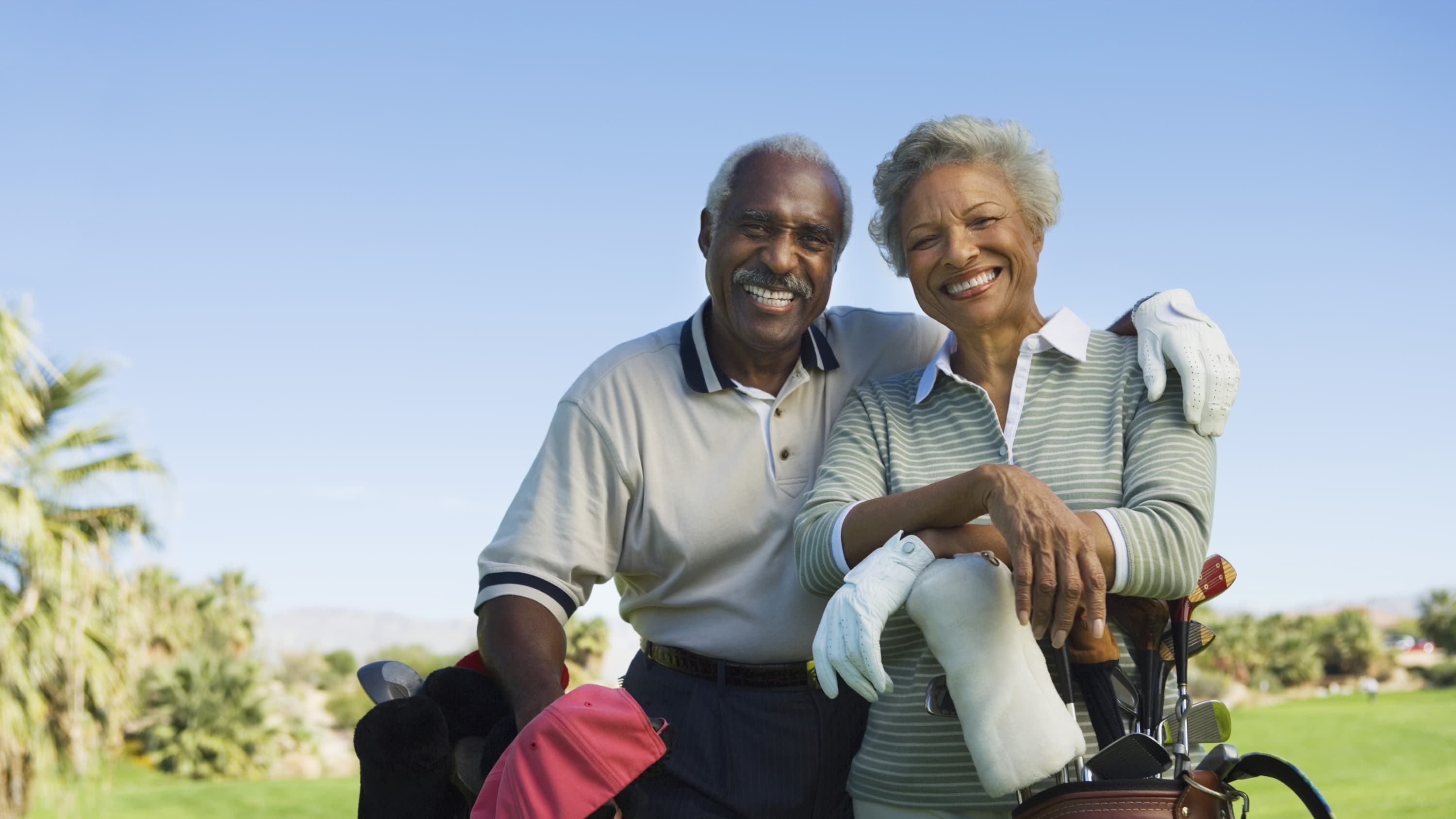 A couple playing golf, possibly after aortic aneurysm surgery