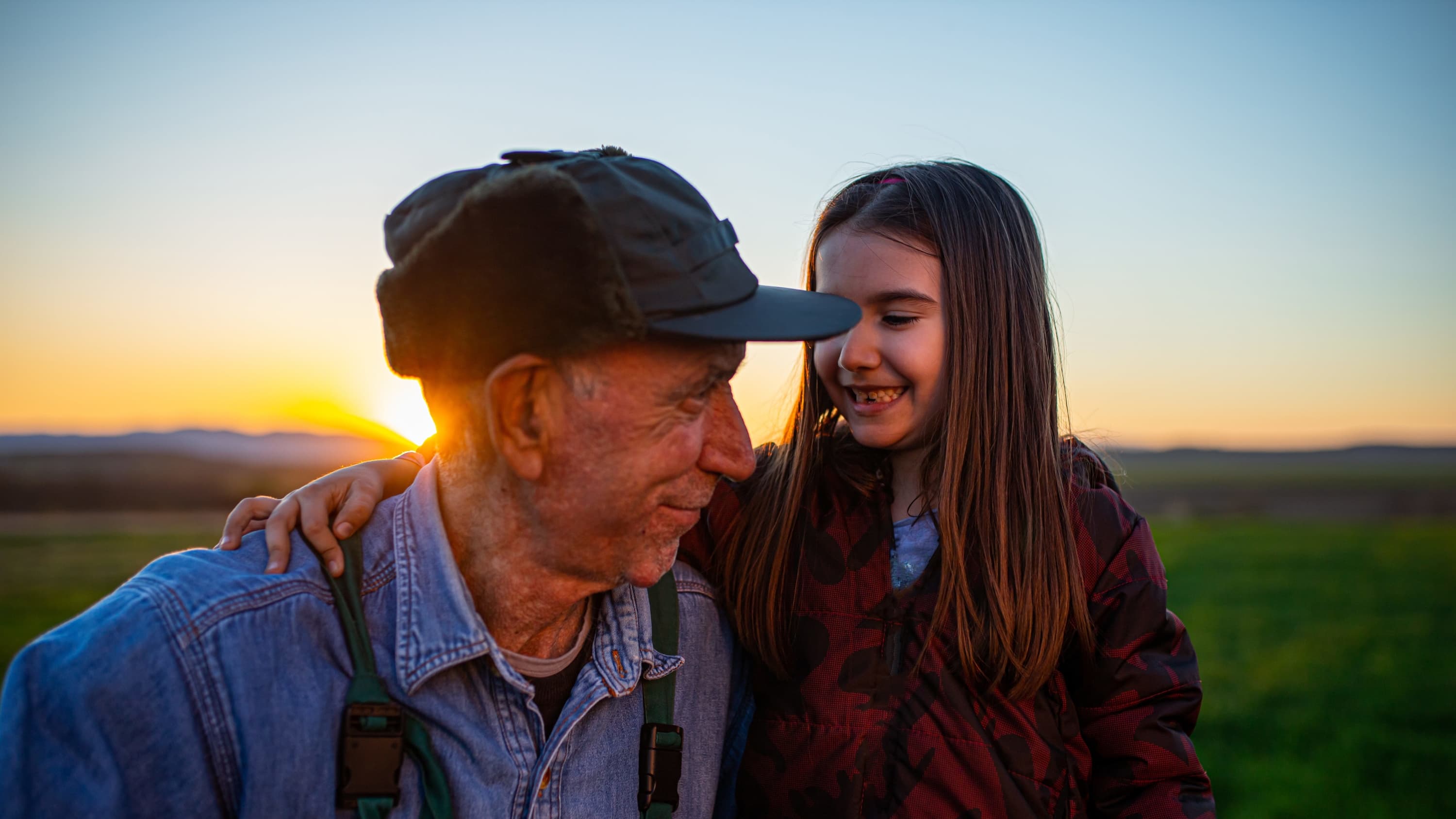 farmer and granddaughter smiling after his treatment for merkel cell carcinoma