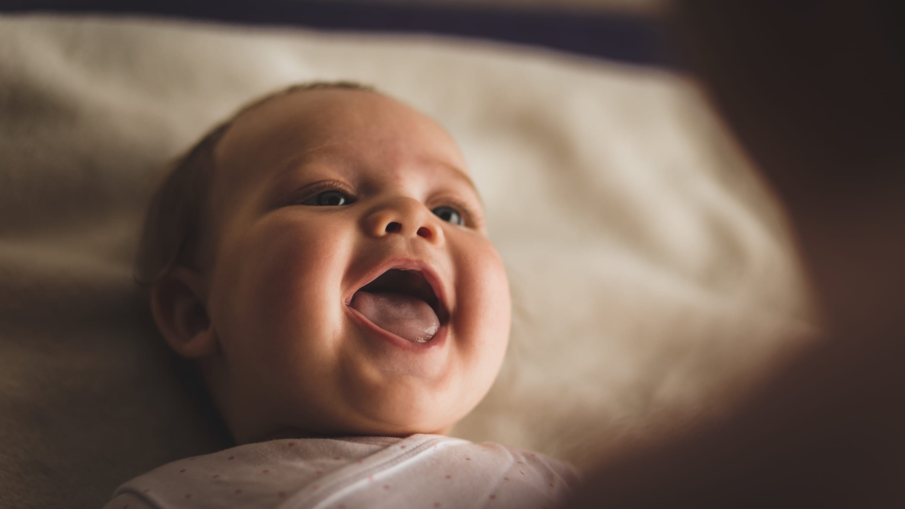 baby smiling, unaware of having patent ductus arteriosus (PDA)