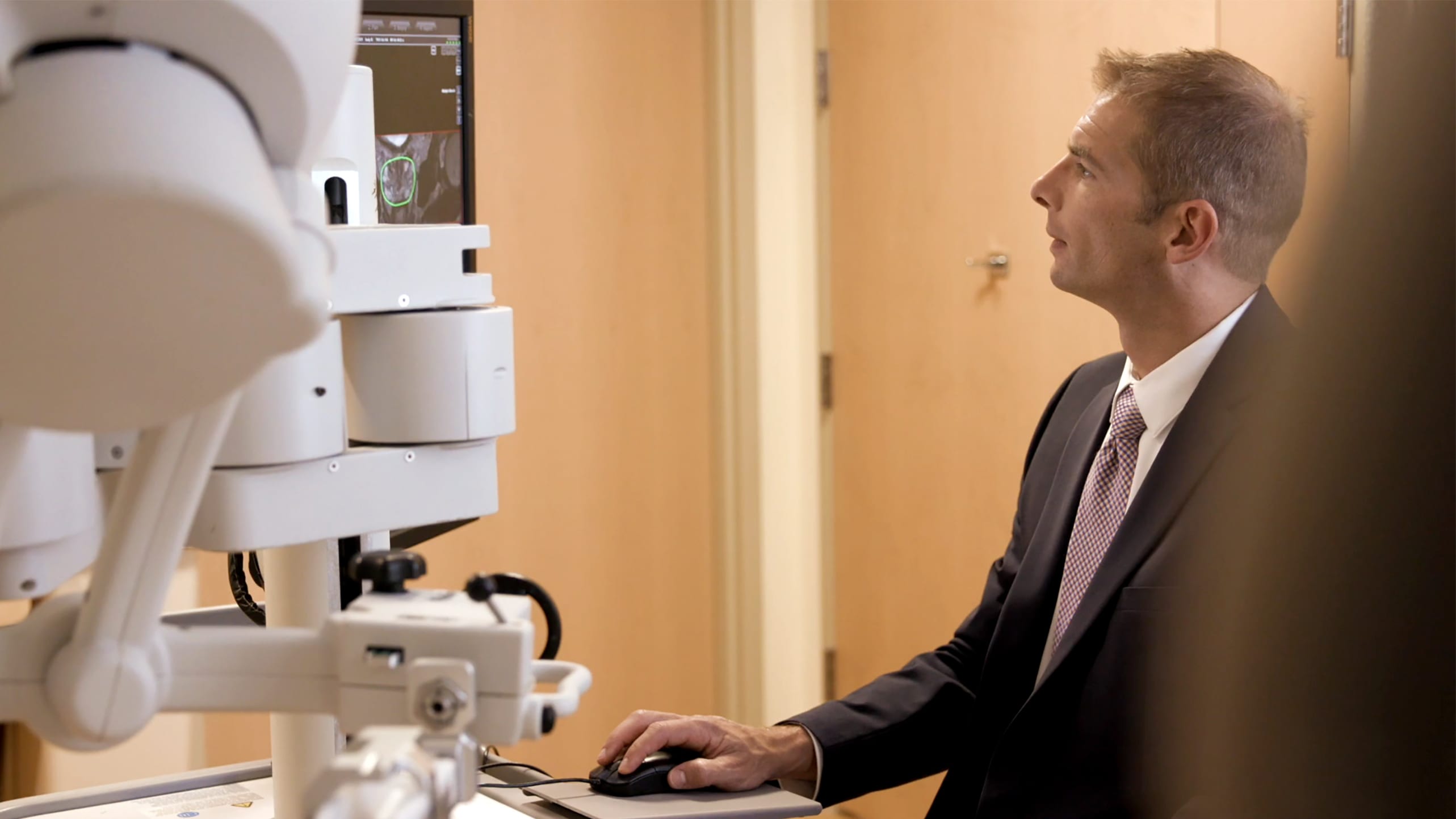 A doctor examines imaging to detect prostate cancer.