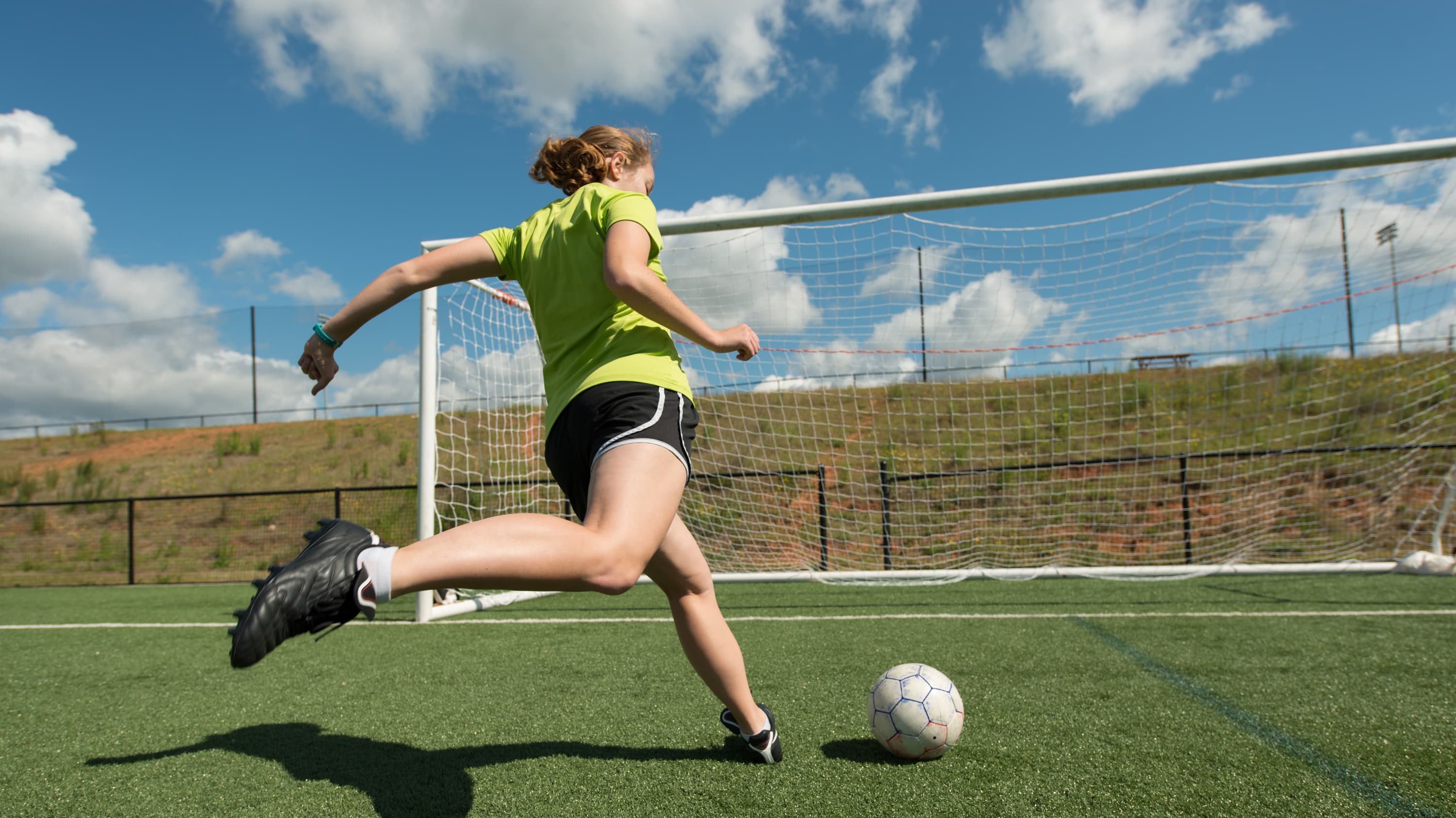soccer player kicking a ball