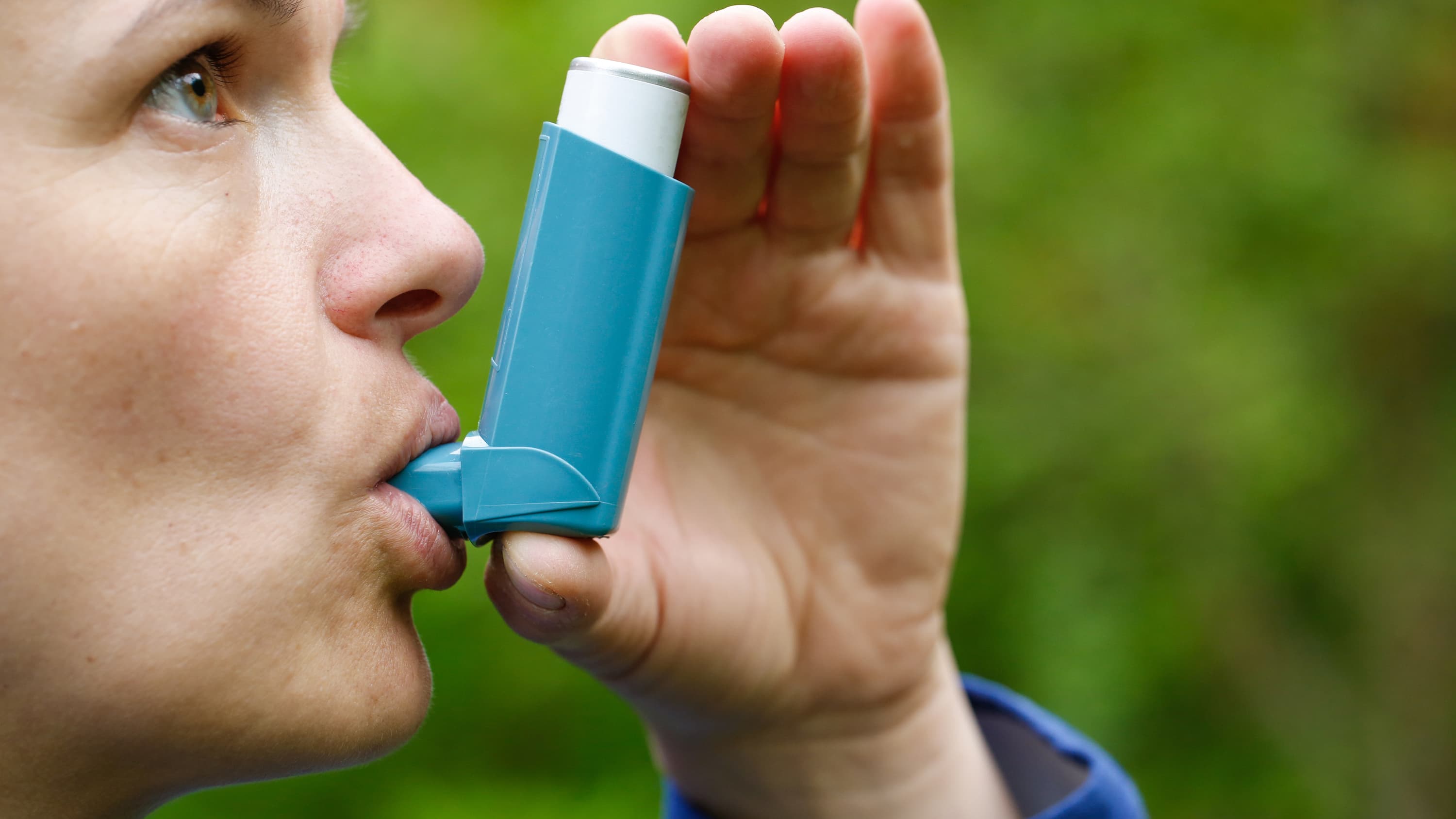 A woman with chronic obstructive pulmonary disease is using a blue inhaler.