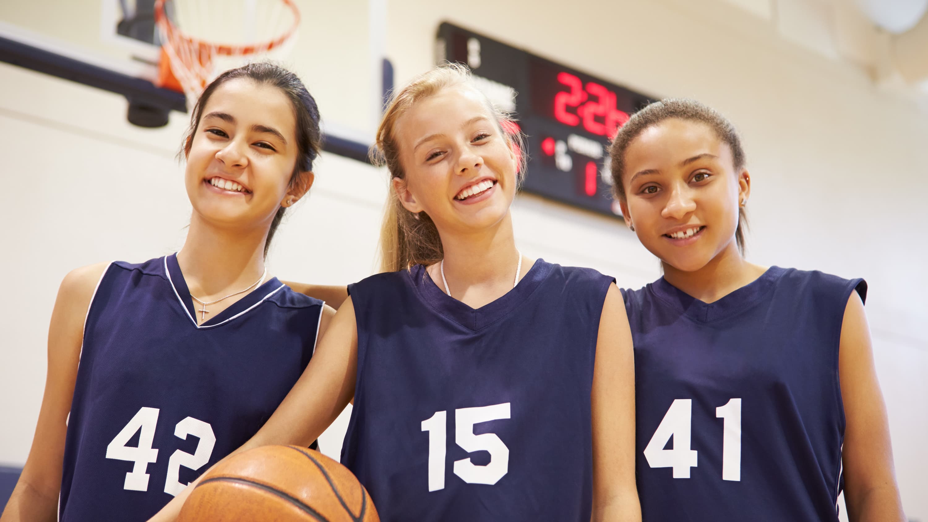 girls holding a basketball