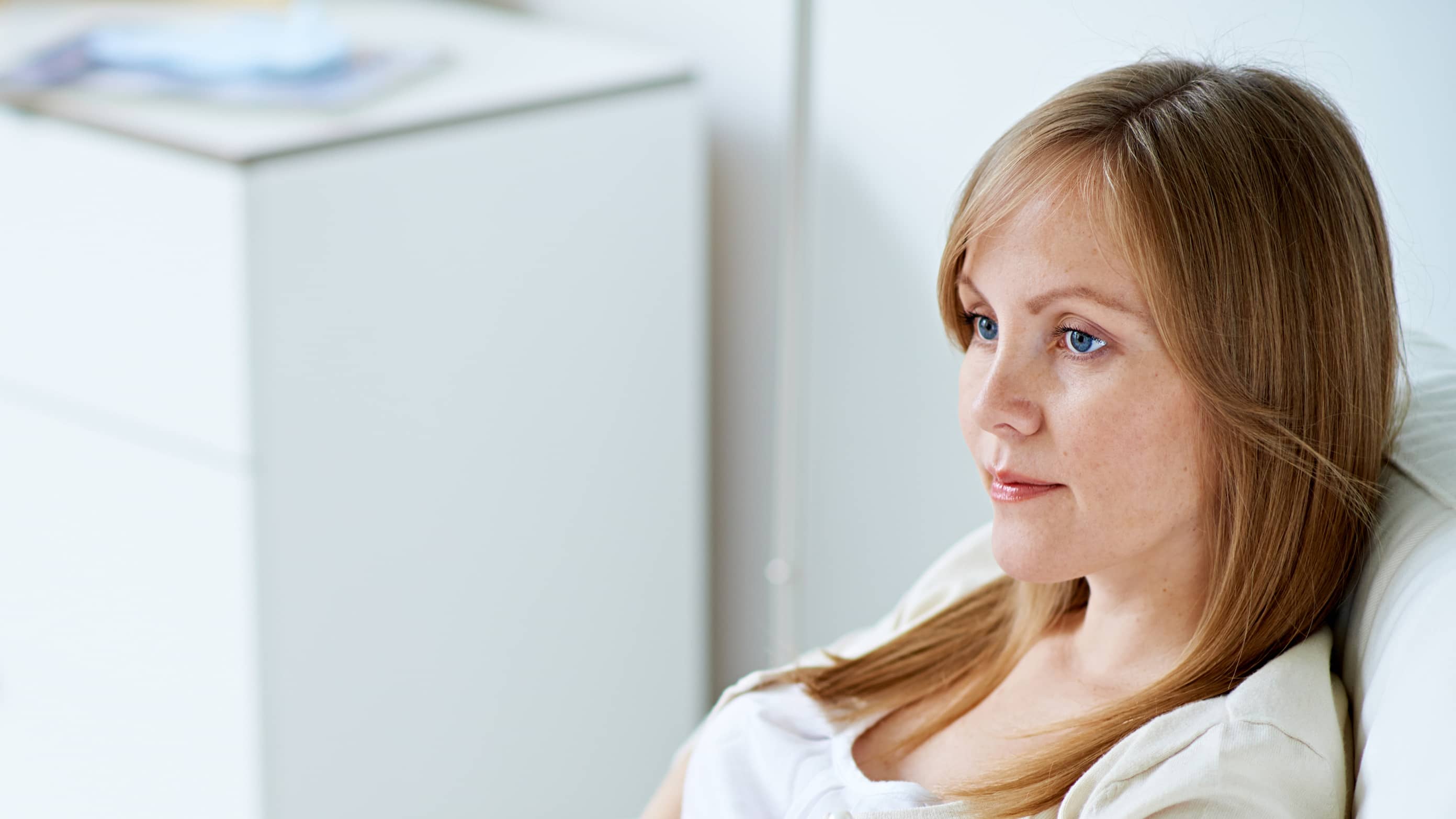 a woman looks concerned, possibly because of recurrent pregnancy loss.