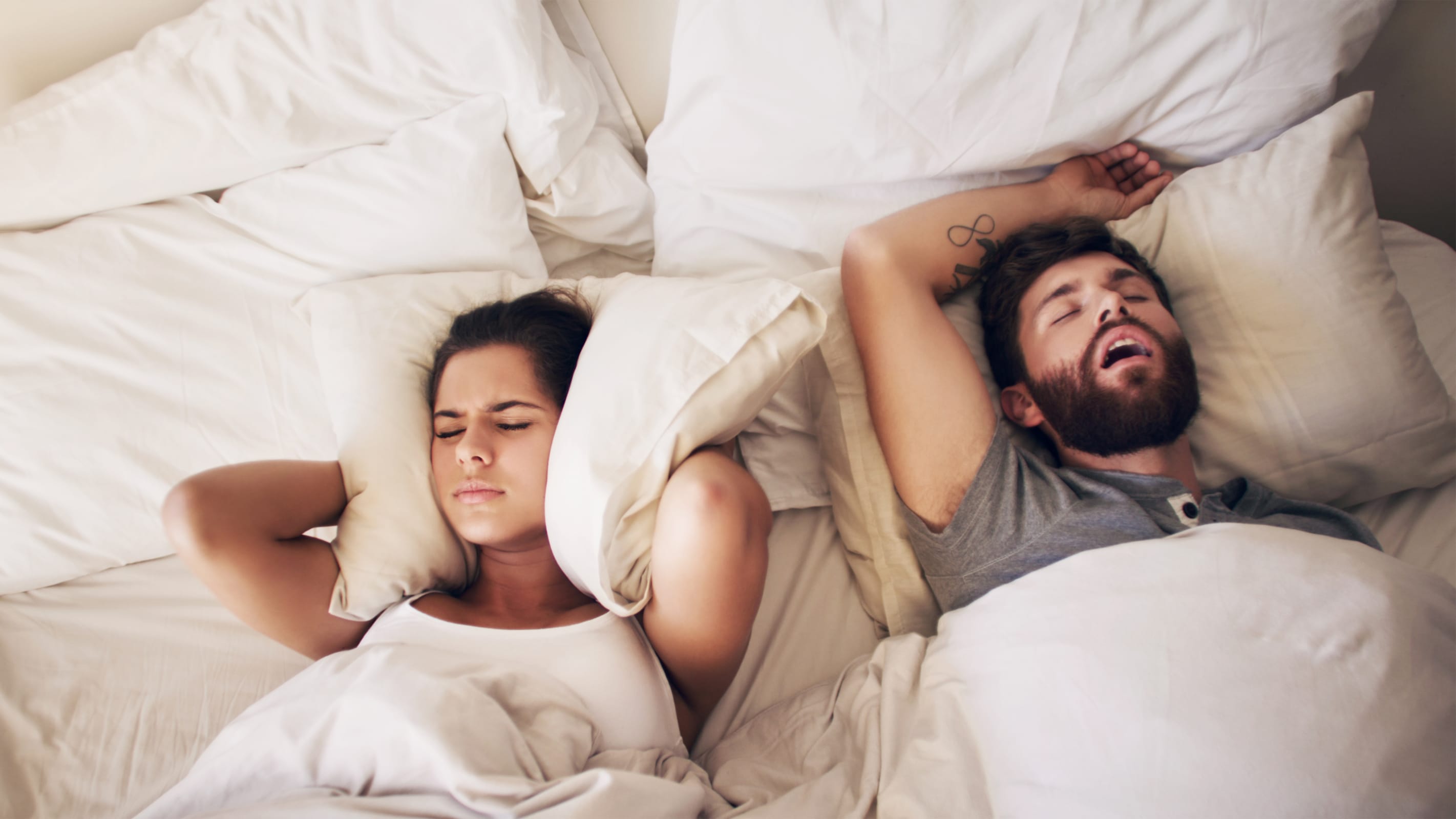 couple in bed, man snoring