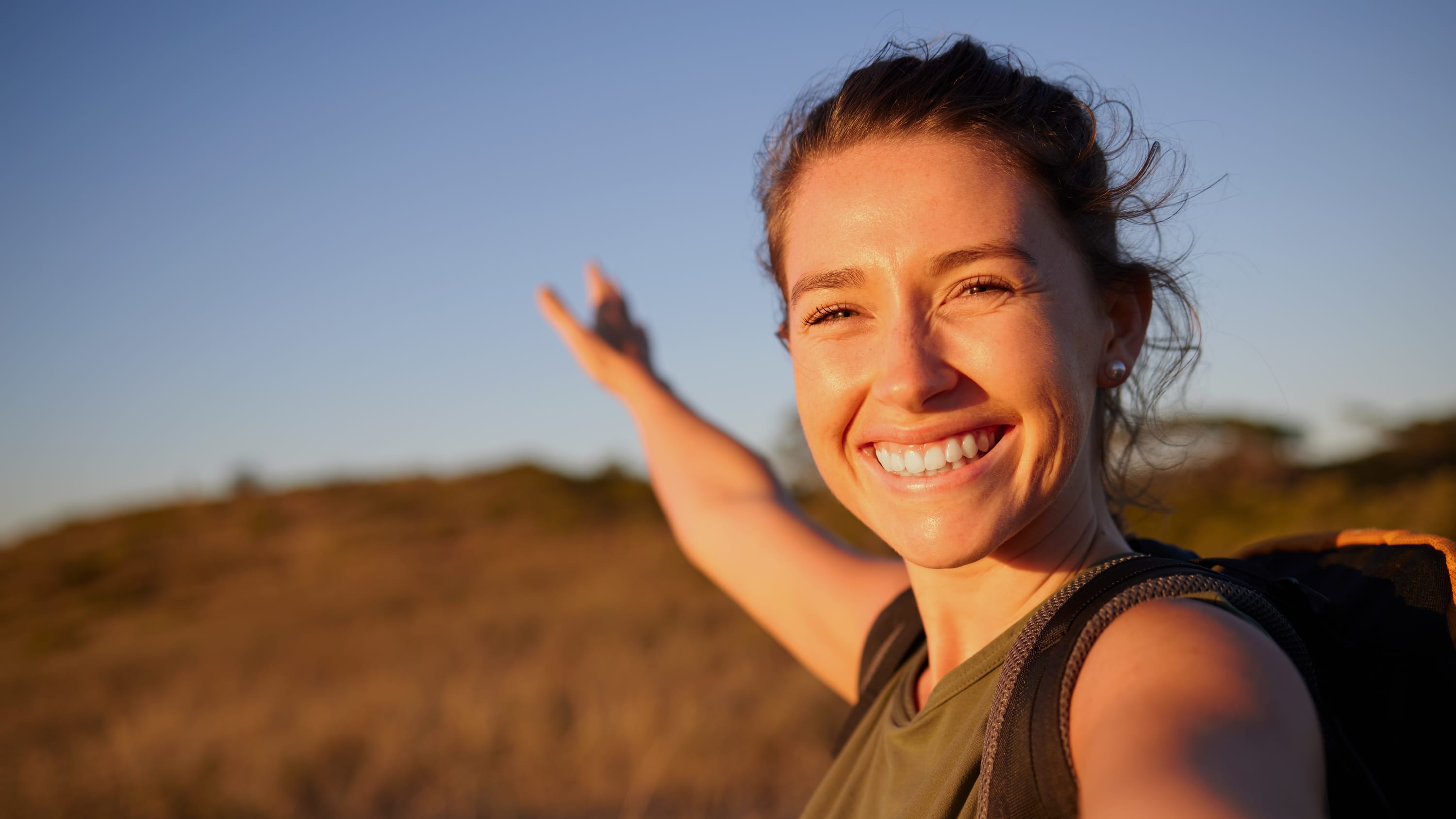woman smiling in a field after uterine fibroid embolization for fibroids