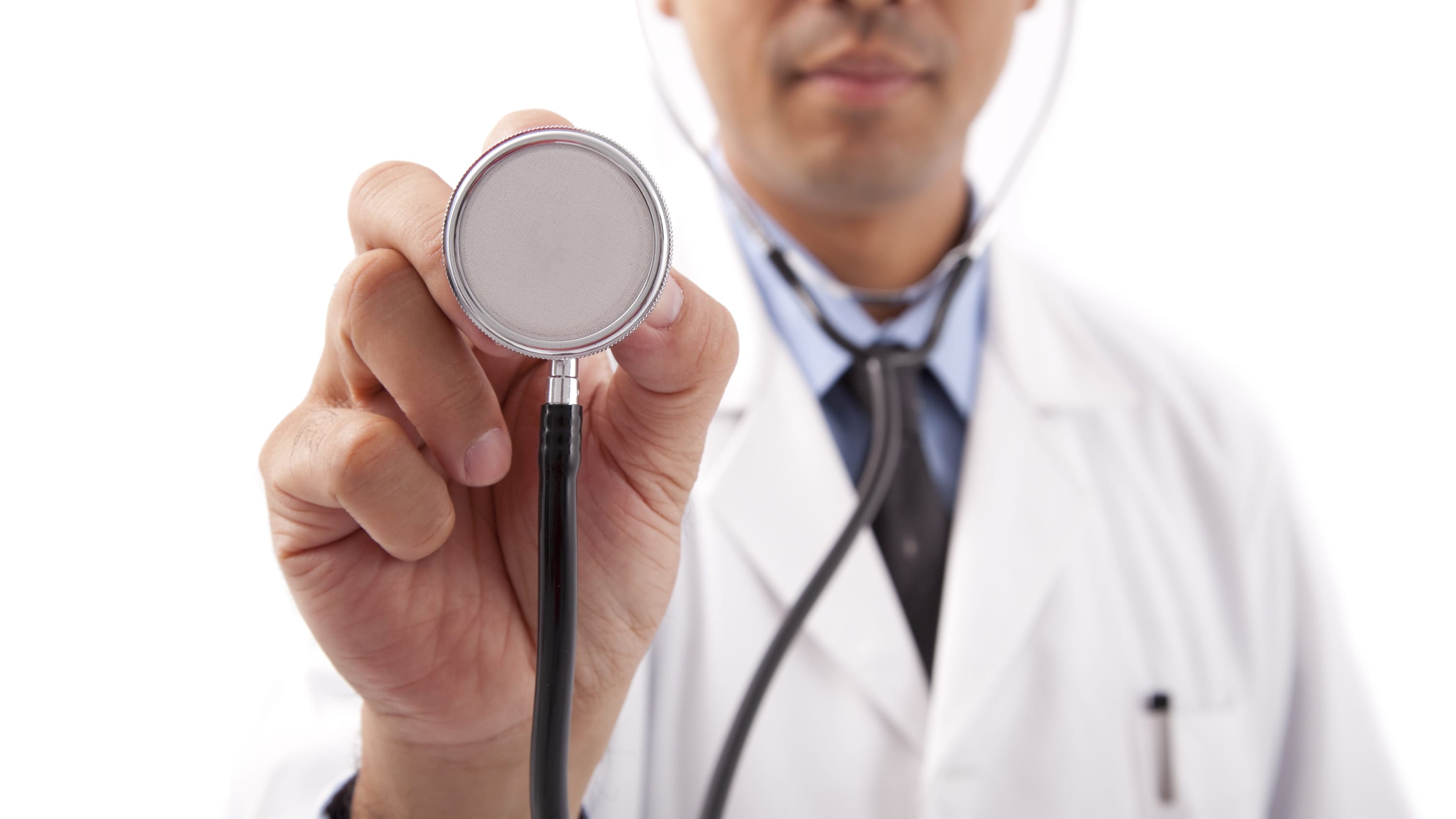 A doctor holds up a stethoscope used to examine a patient who may have a cardiomyopathy.