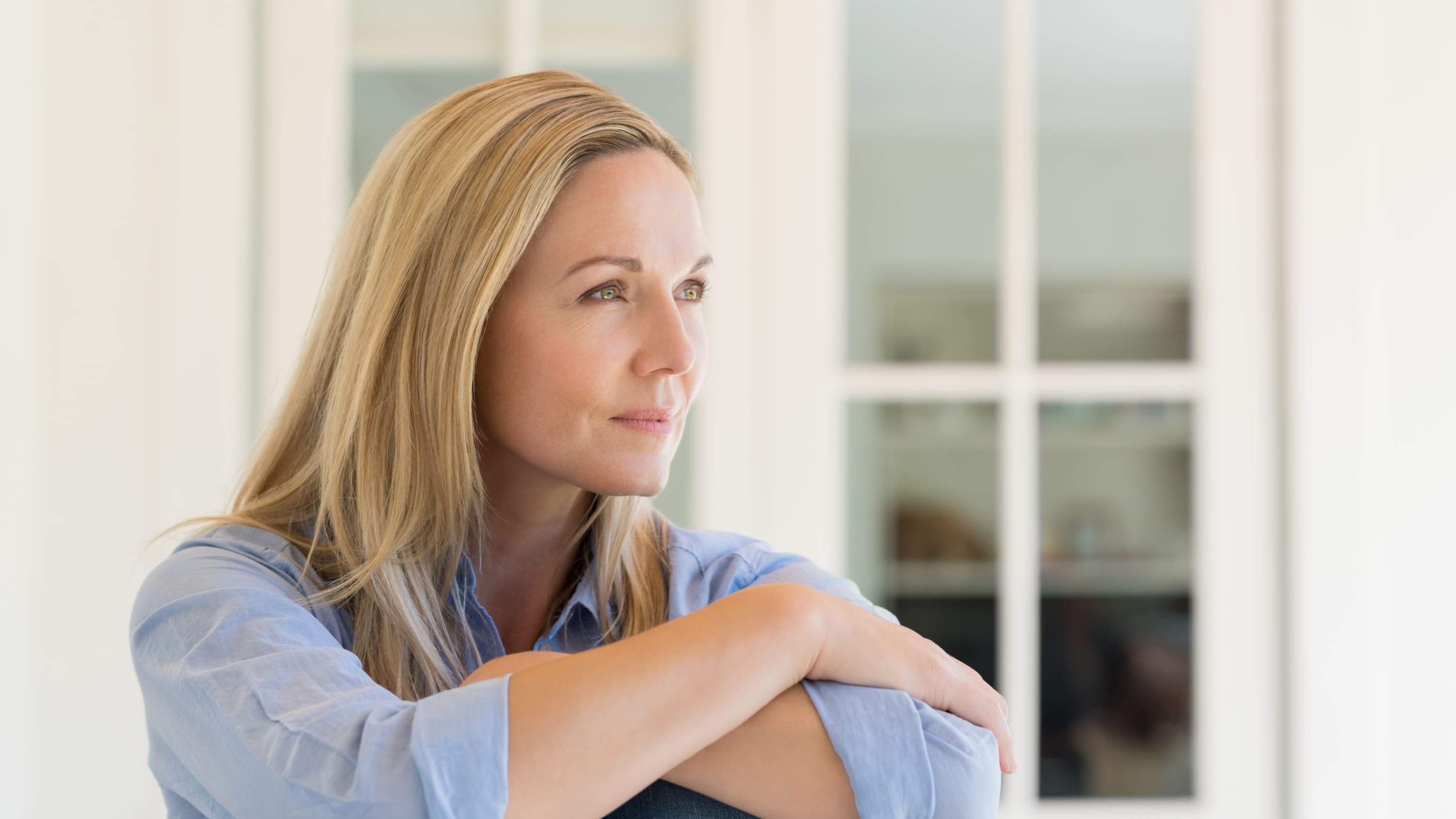 A woman is deep in thought, possibly thinking about neurogenic bladder