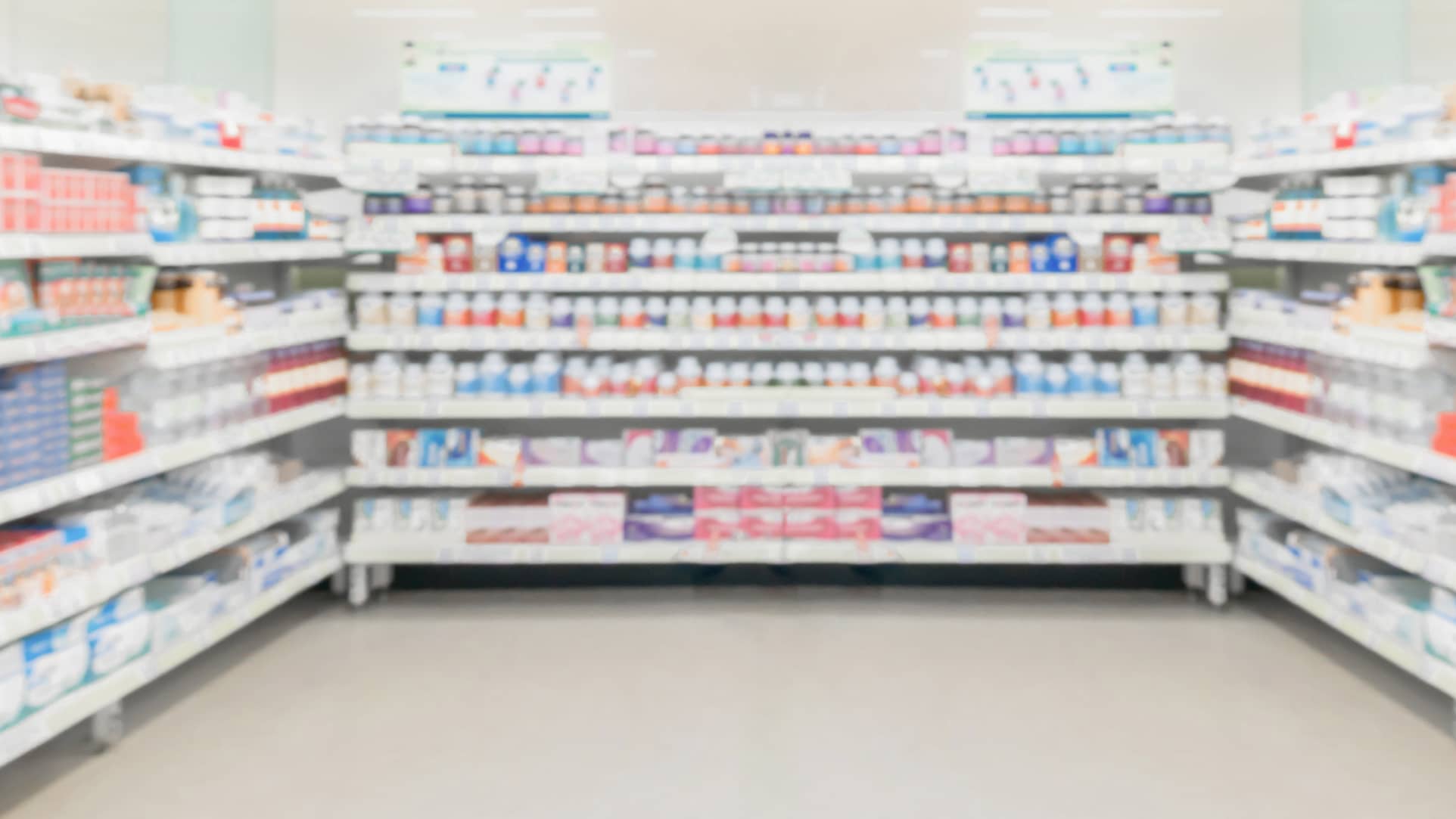 pharmacy aisle with shelves of OTC pain medicines