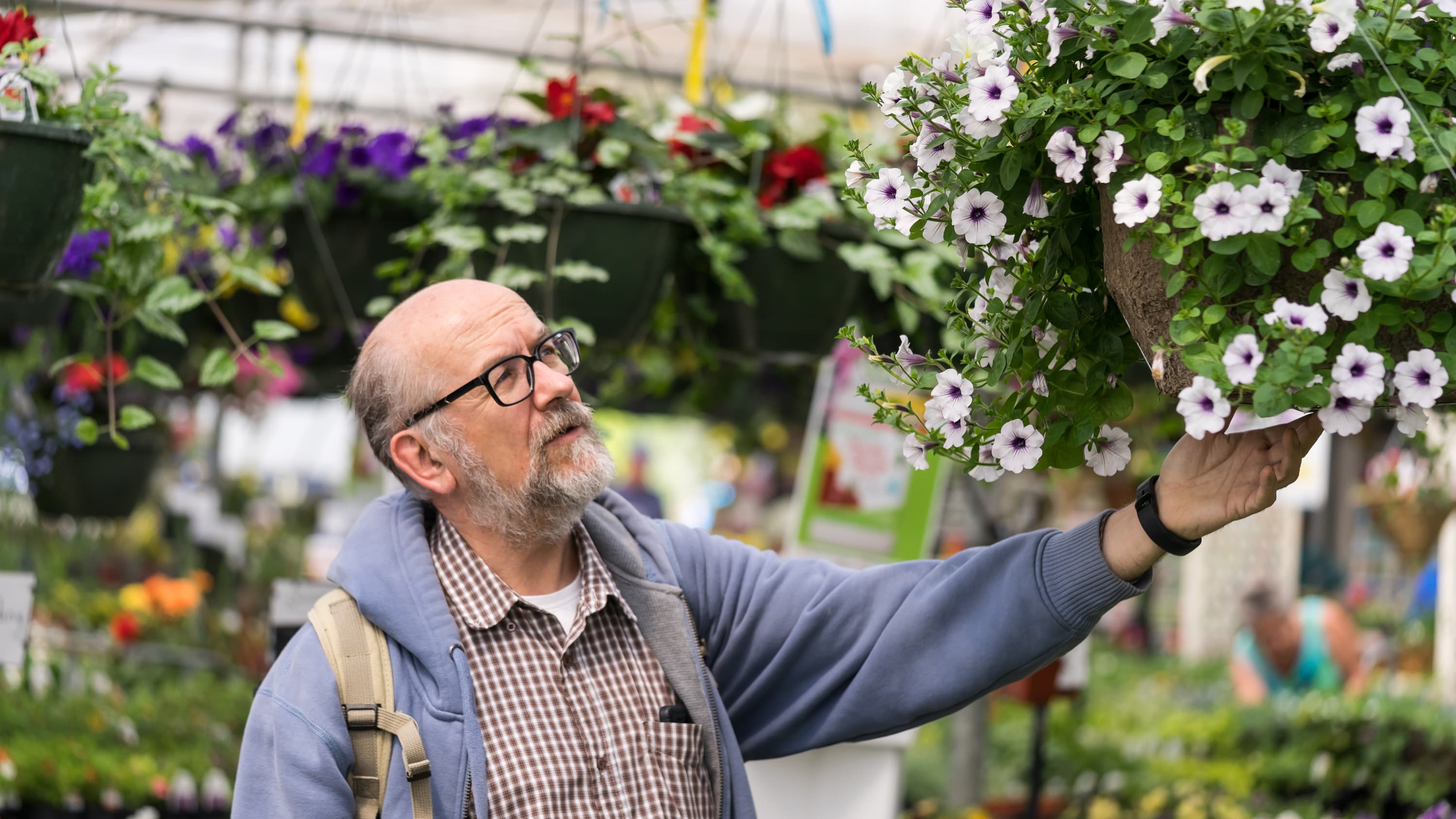 A man who may have had bladder cancer enjoys a garden walk.