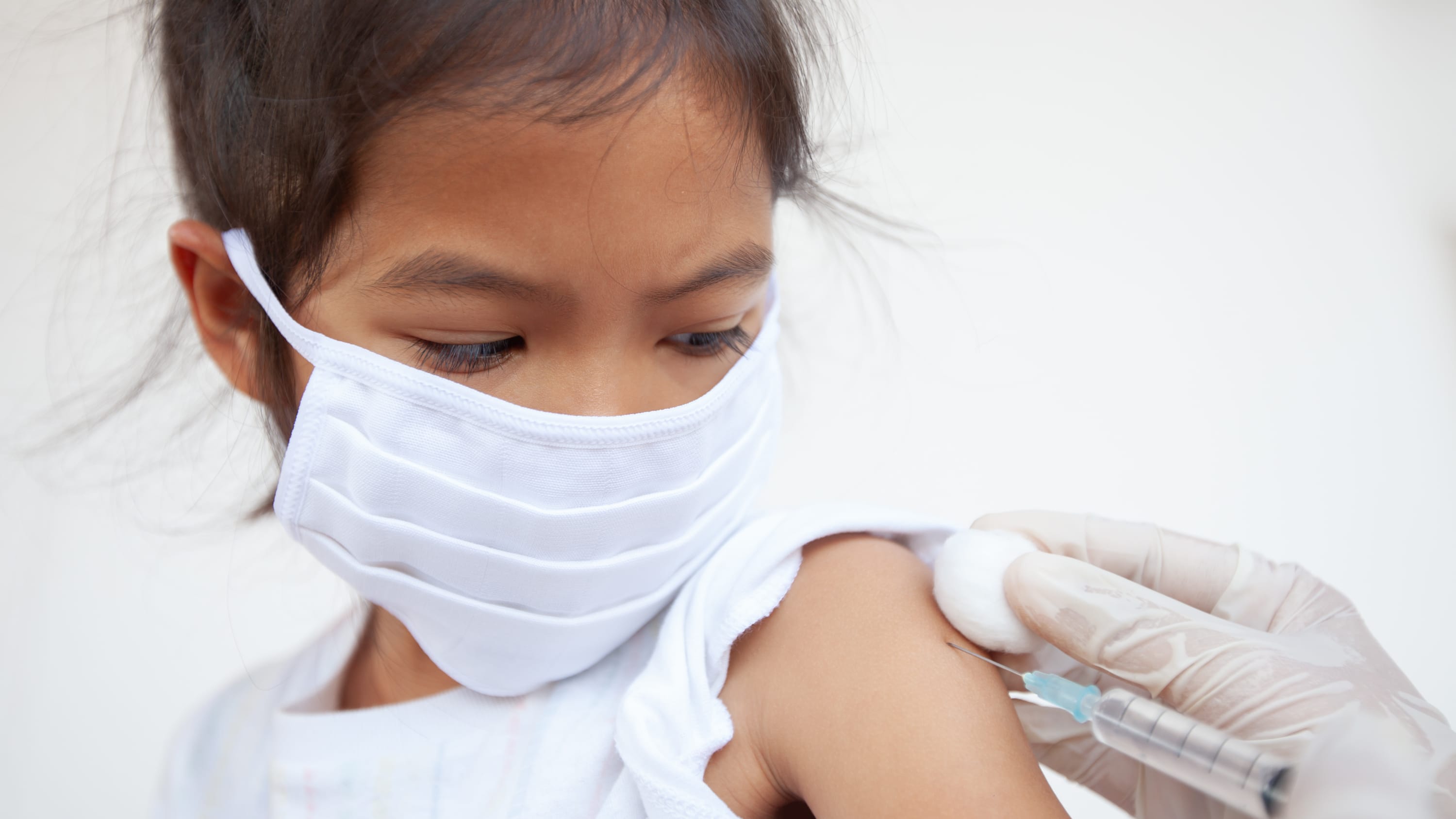 girl receiving a vaccine, potentially for COVID-19
