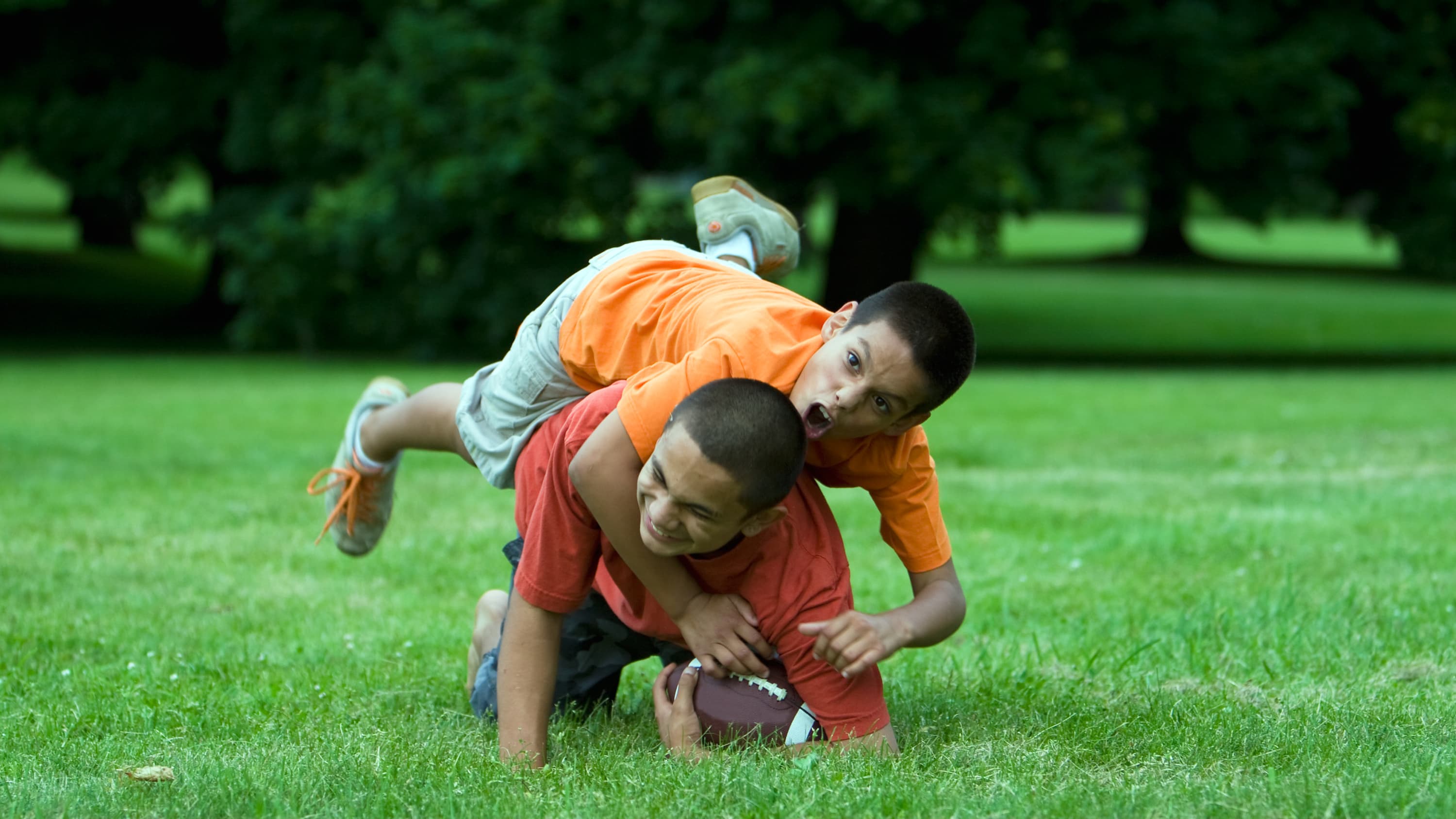 two kids playing football