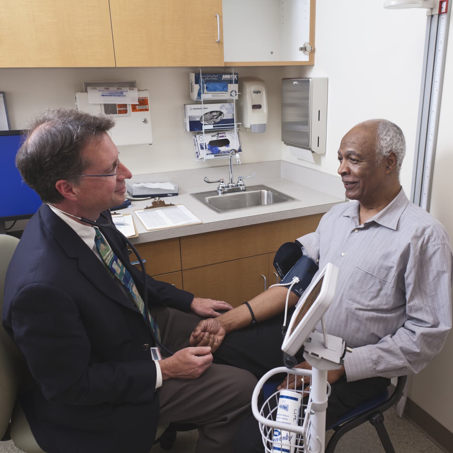 Dr. Gill taking a patient's blood pressure