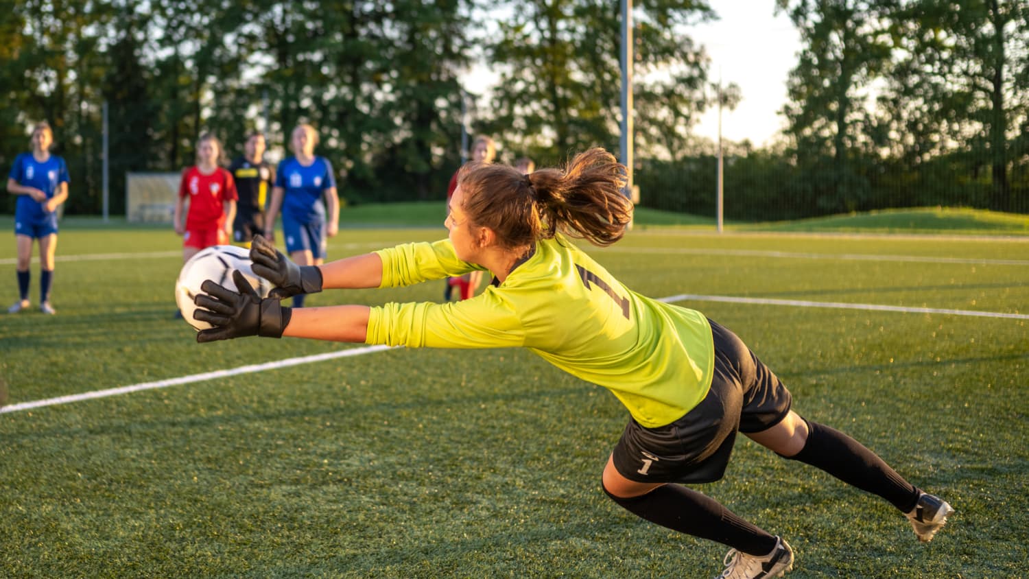 young girl goalie blocking shot avoiding injuries treated at Female Athlete+ Program