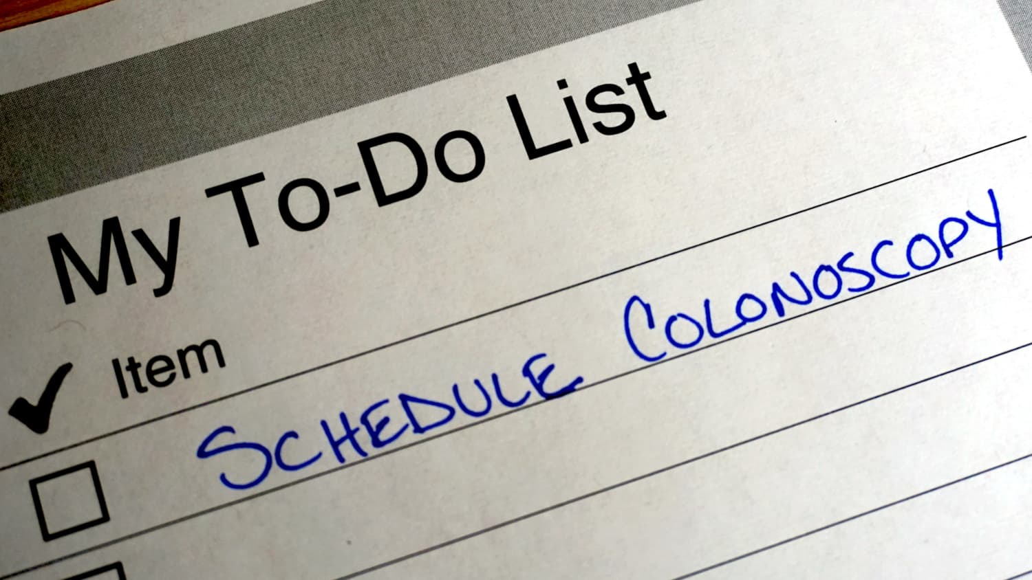 planner with note about scheduling a colonoscopy to remove colon polyps