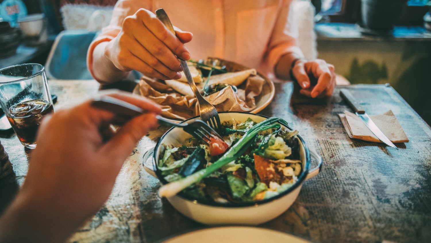 man and woman sharing food, highlighting the importance of anti-obesity medications in the treatment of obesity