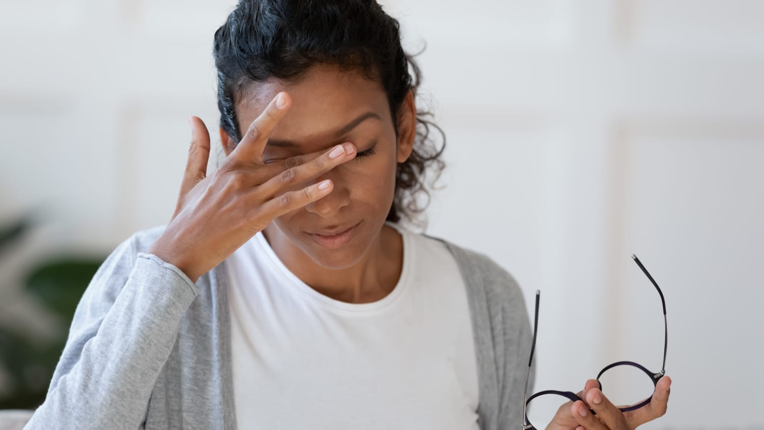 A woman with chronic dry eye takes rubs her eyes for relief