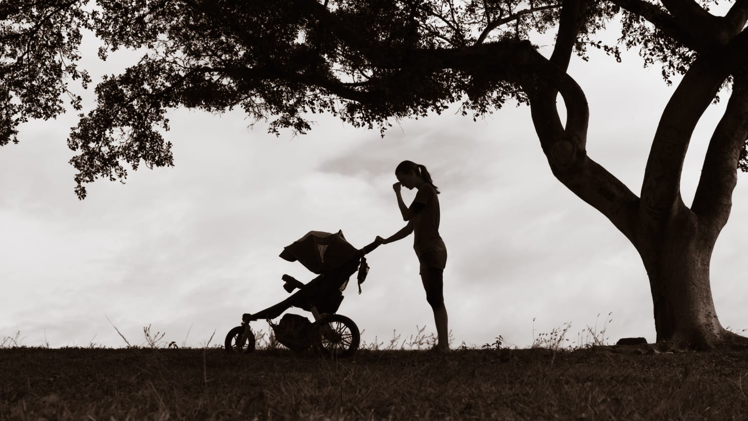 mother with postpartum depression pushing a stroller outside