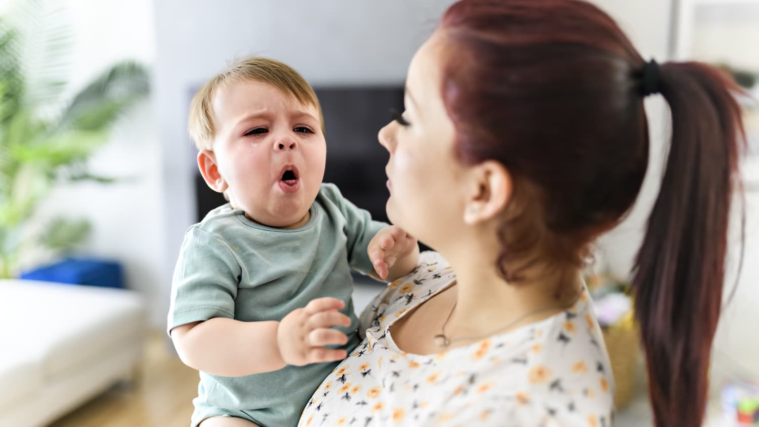mom holding a baby with whooping cough (pertussis)
