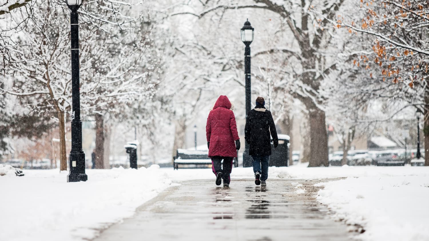 people walking on ice and snow illustrating how falls can be dangerous for your back