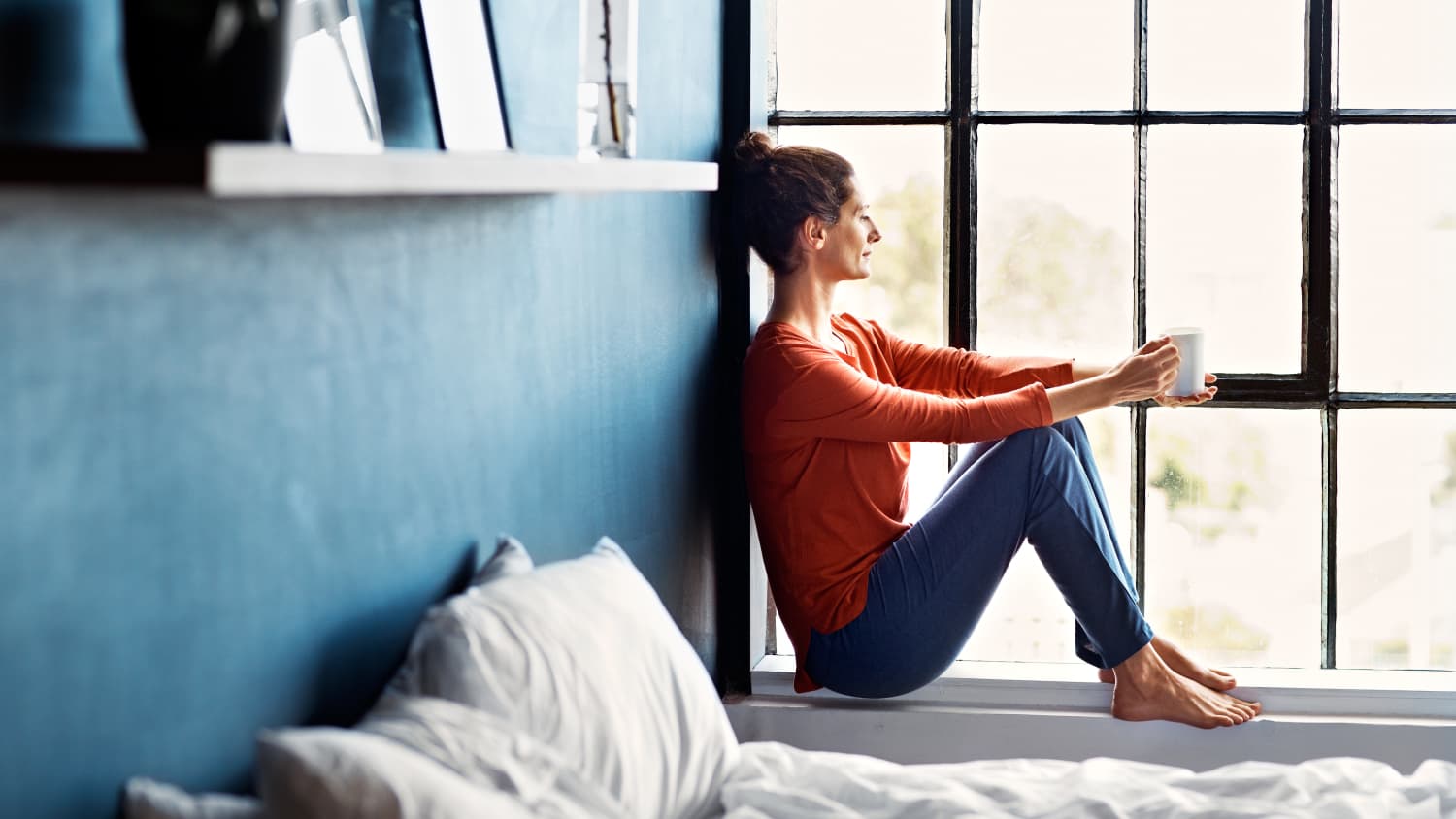 woman with early or premature menopause looking out a window