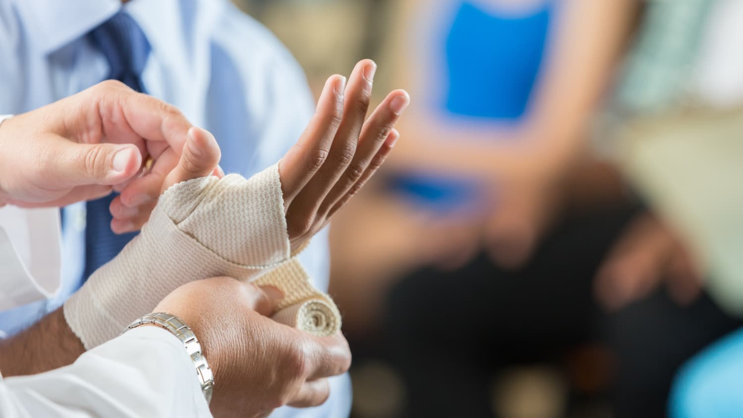 Doctor Bandages Patient's Hand