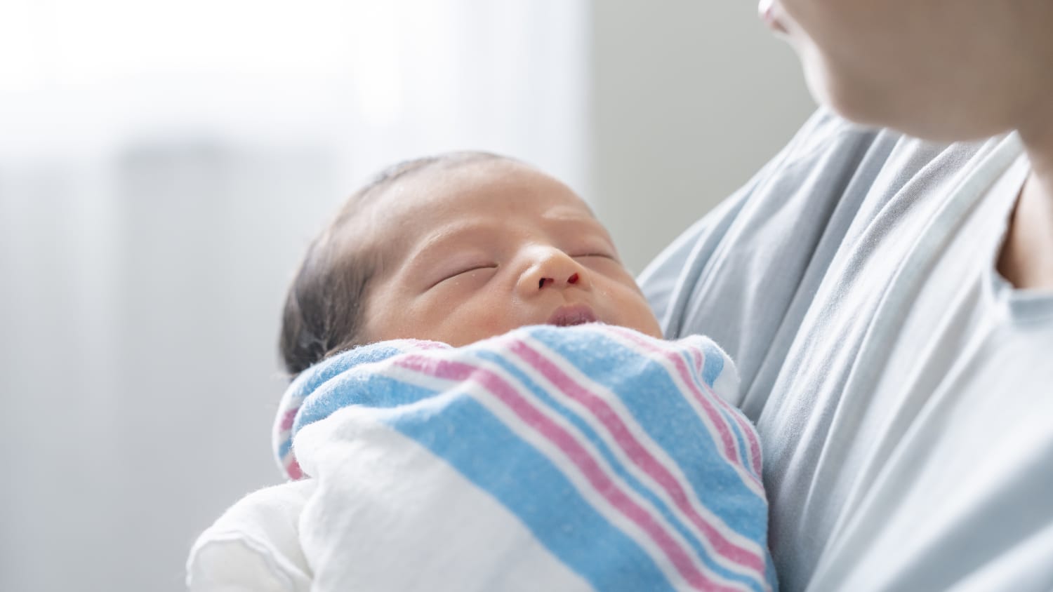 newborn baby with mother after fetal surgery