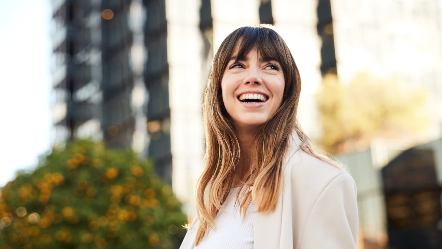 young woman smiling after receiving interventional psychiatry treatments