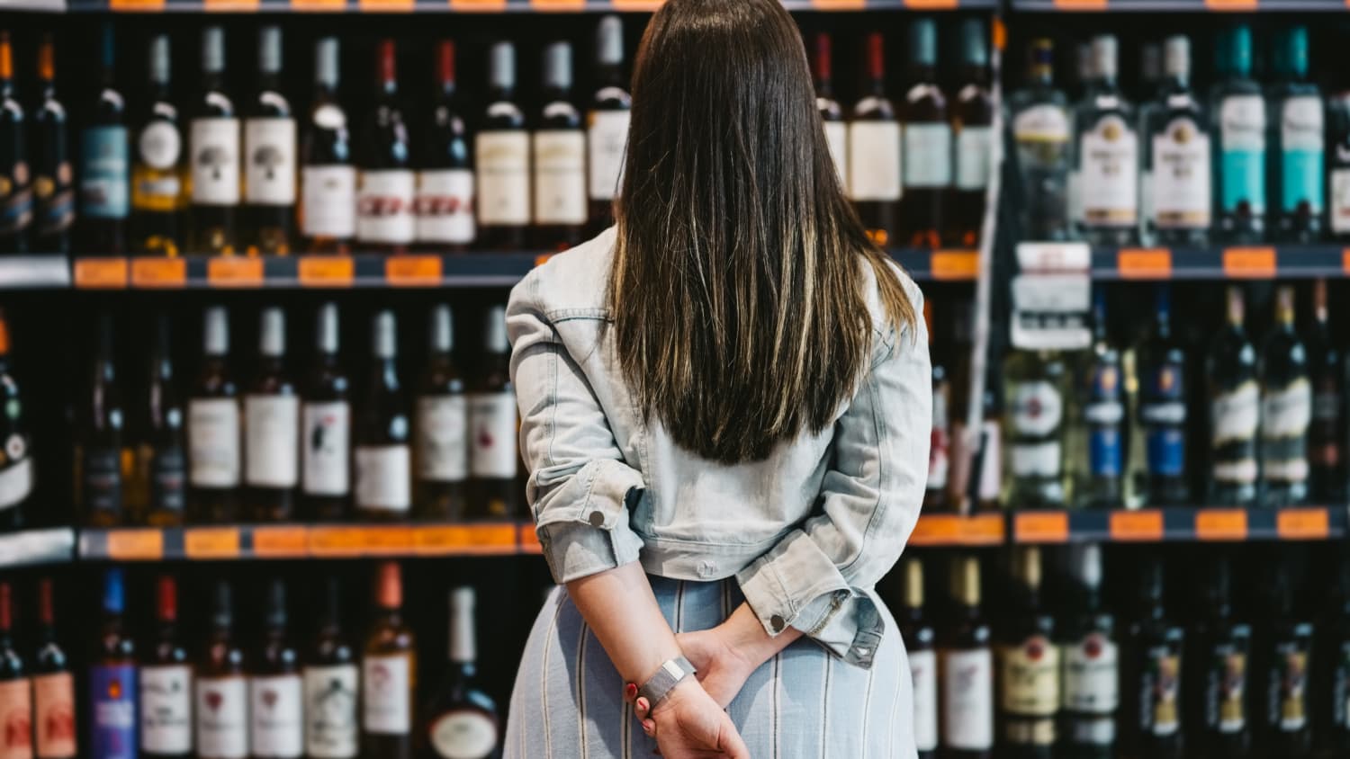 Woman Looks at Wine Rack
