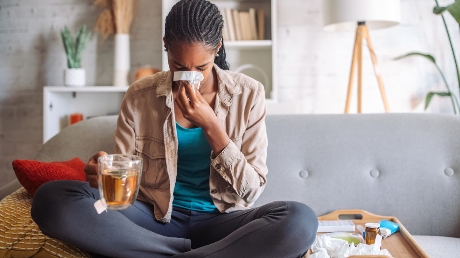 Woman with human metapneumovirus (HMPV) blowing her nose