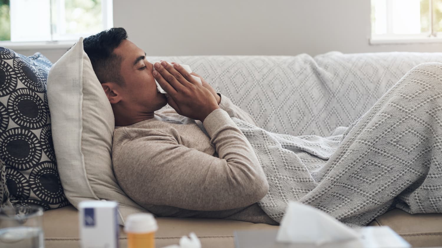 person on couch sick with the flu