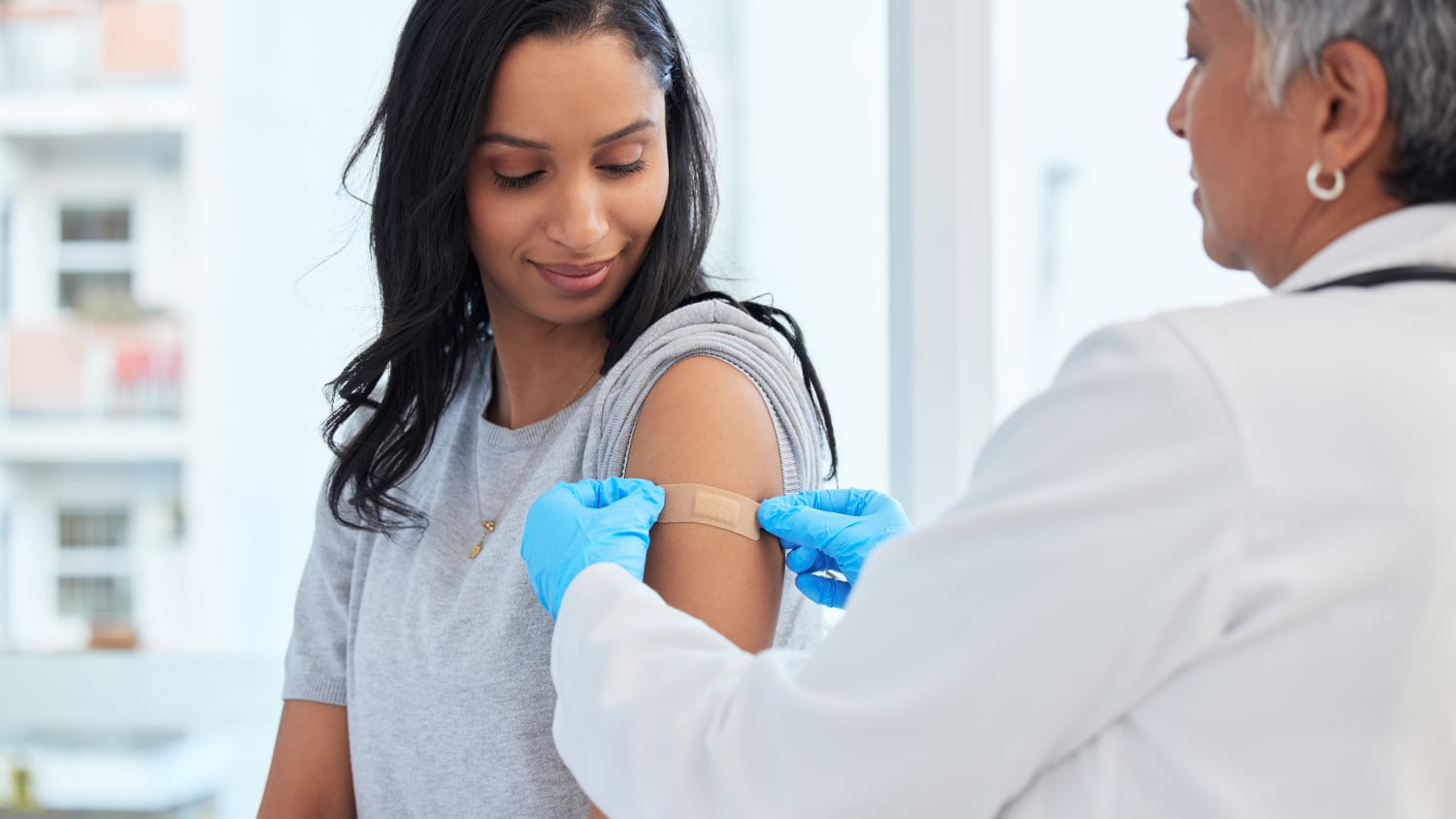 woman receiving updated 2024-2025 COVID vaccine