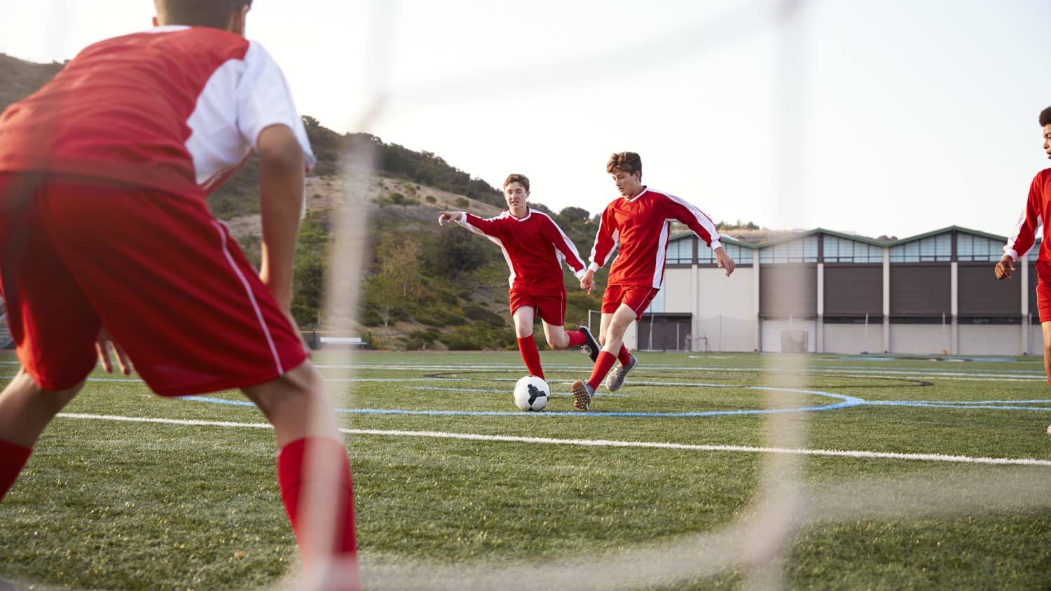 Male High School Students Playing In Soccer Team, highlighting the need for ECG testing for cardiac conditions