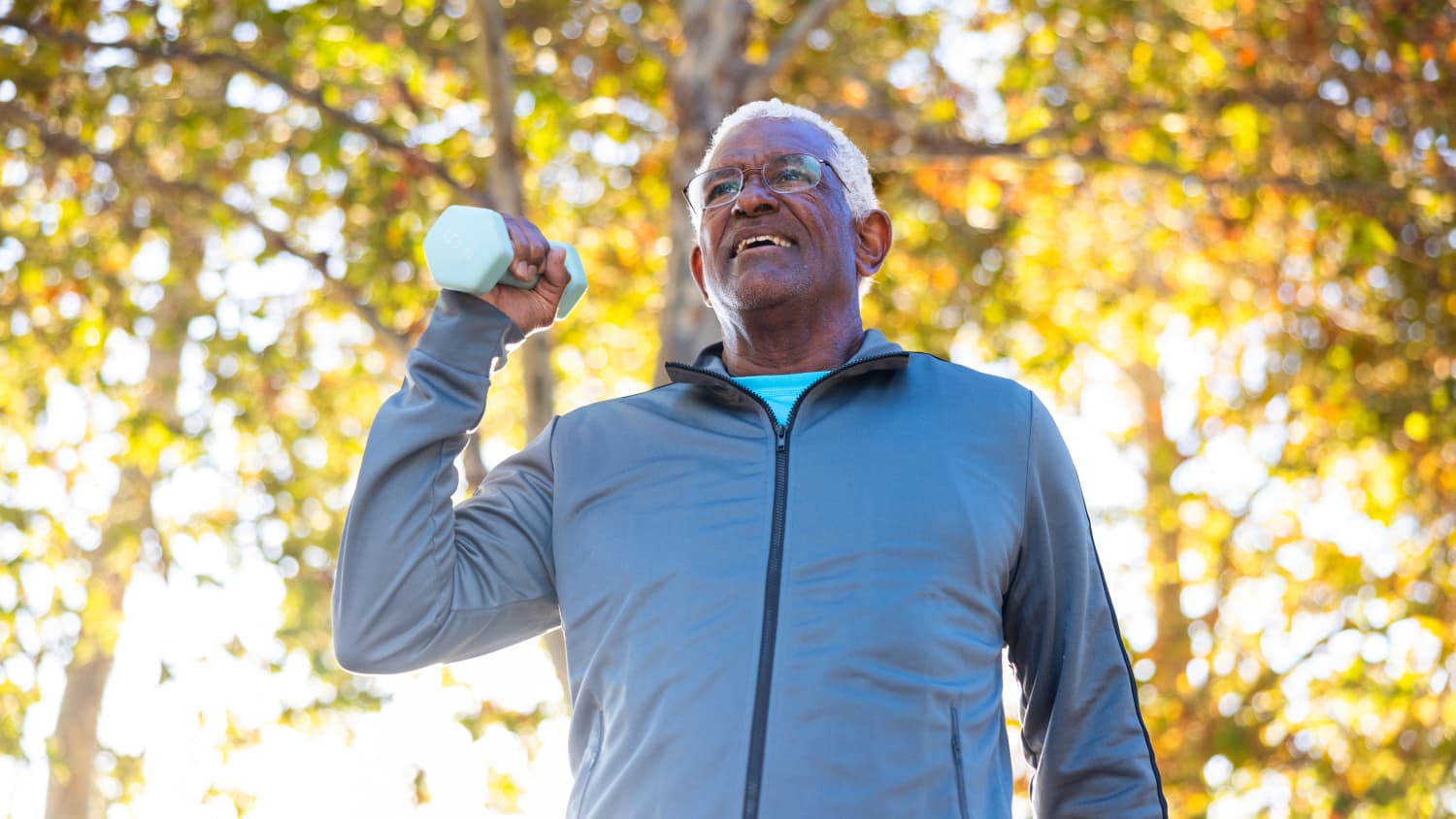 older man with Parkinson's disease lifting weights