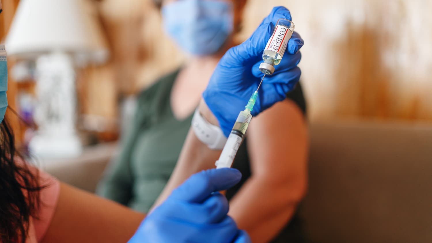 doctor preparing a bivalent COVID-19 vaccine