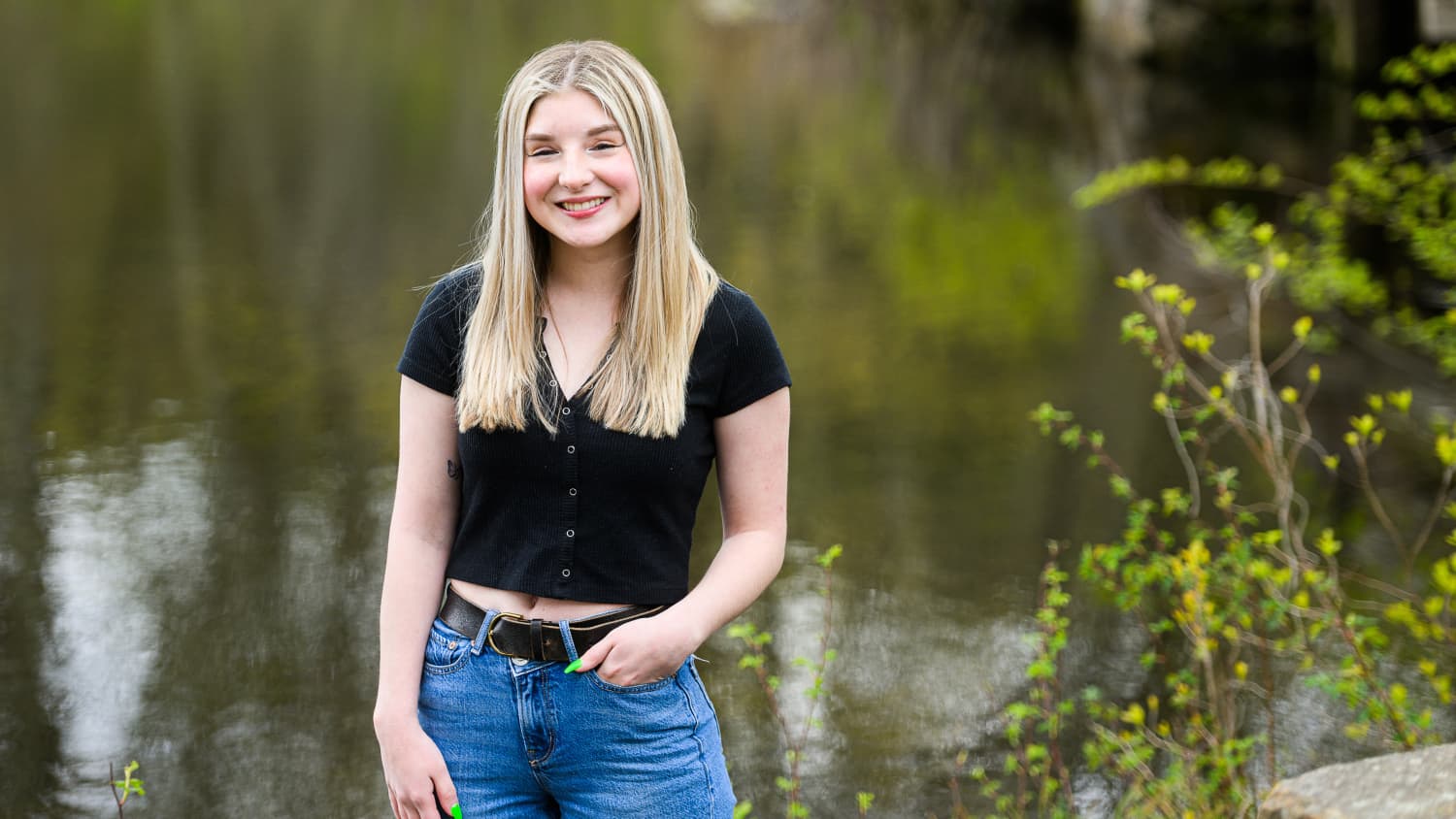 Samantha Marino, a Yale Medicine patient, stands in front of a pond. 