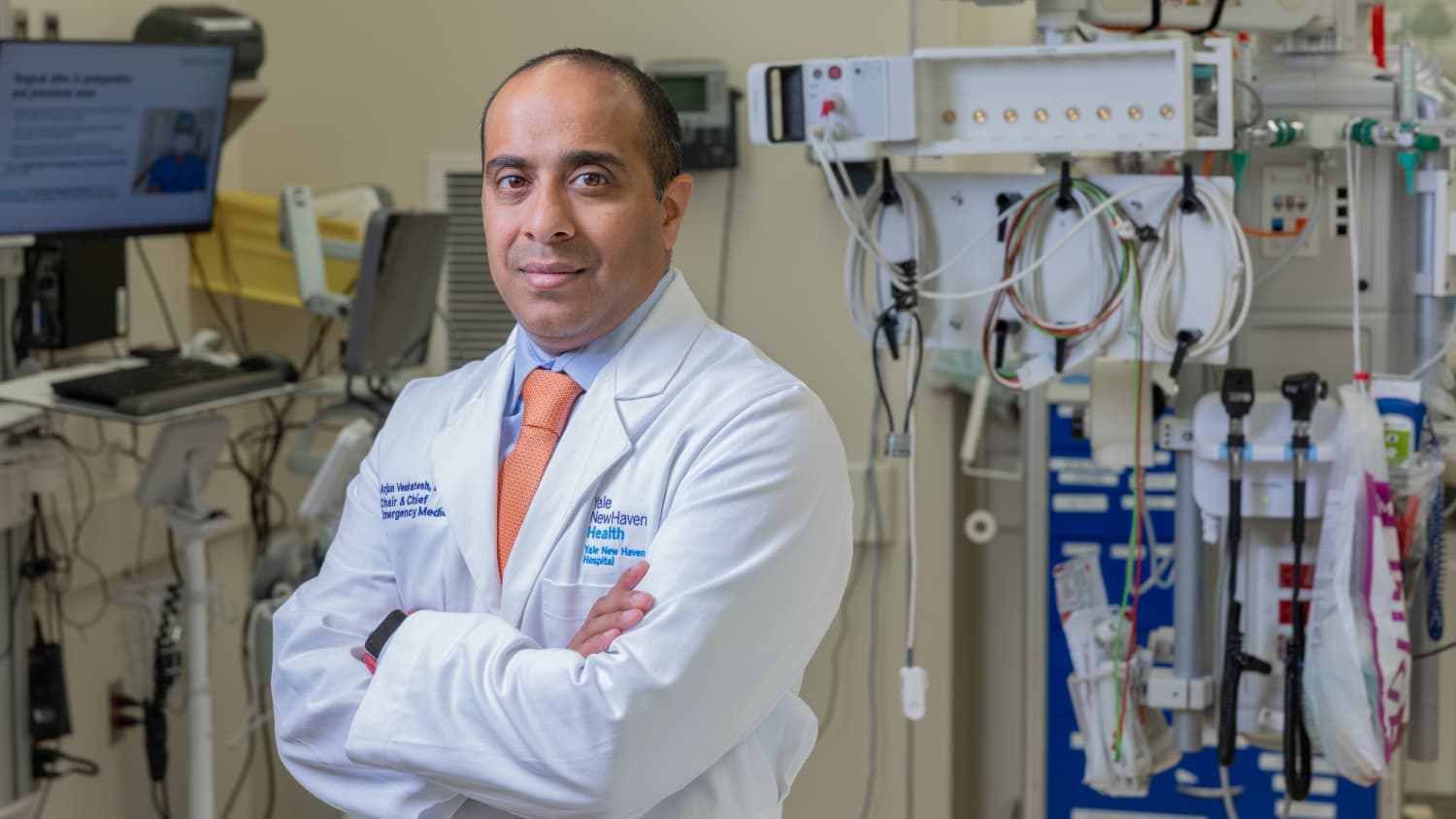 Arjun Venkatesh, MD, poses in a photo with his arms crossed. 