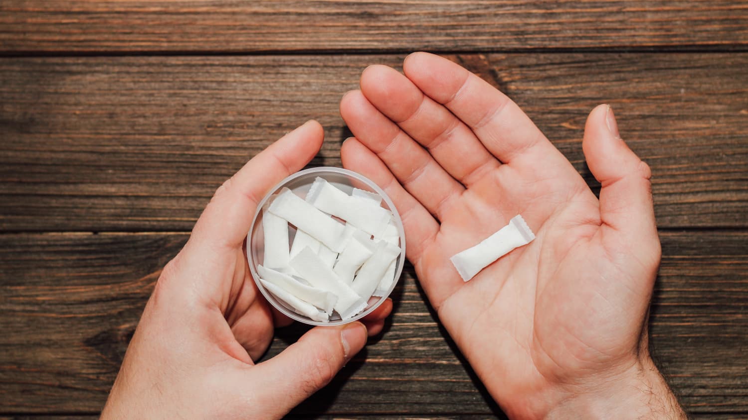 closeup of hands holding nicotine pouches