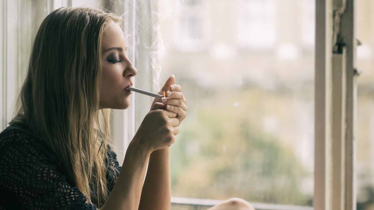 Woman smoking. It's harder for women to quit smoking.