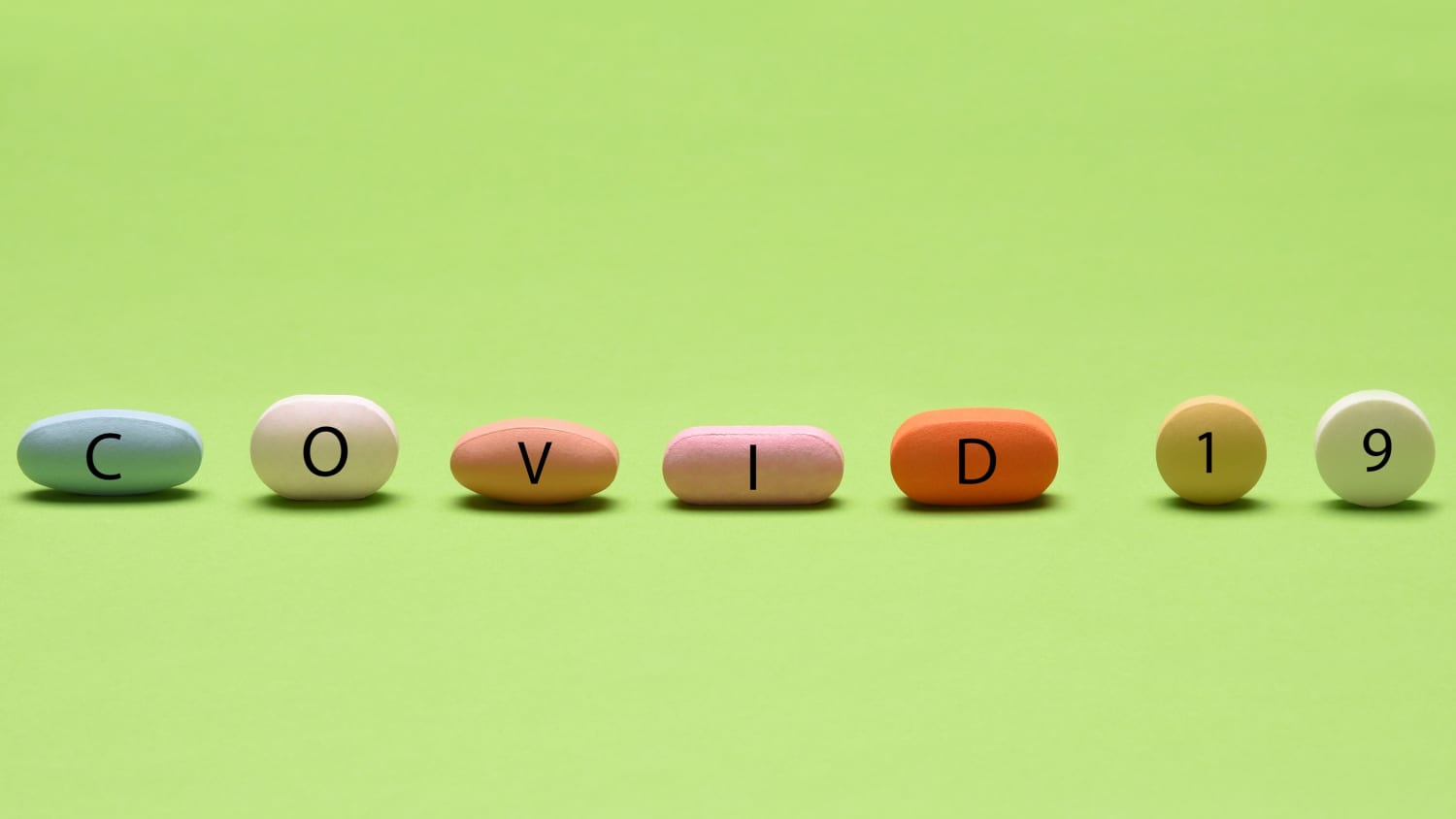pills spelling covid, representing COVID-19 treatments