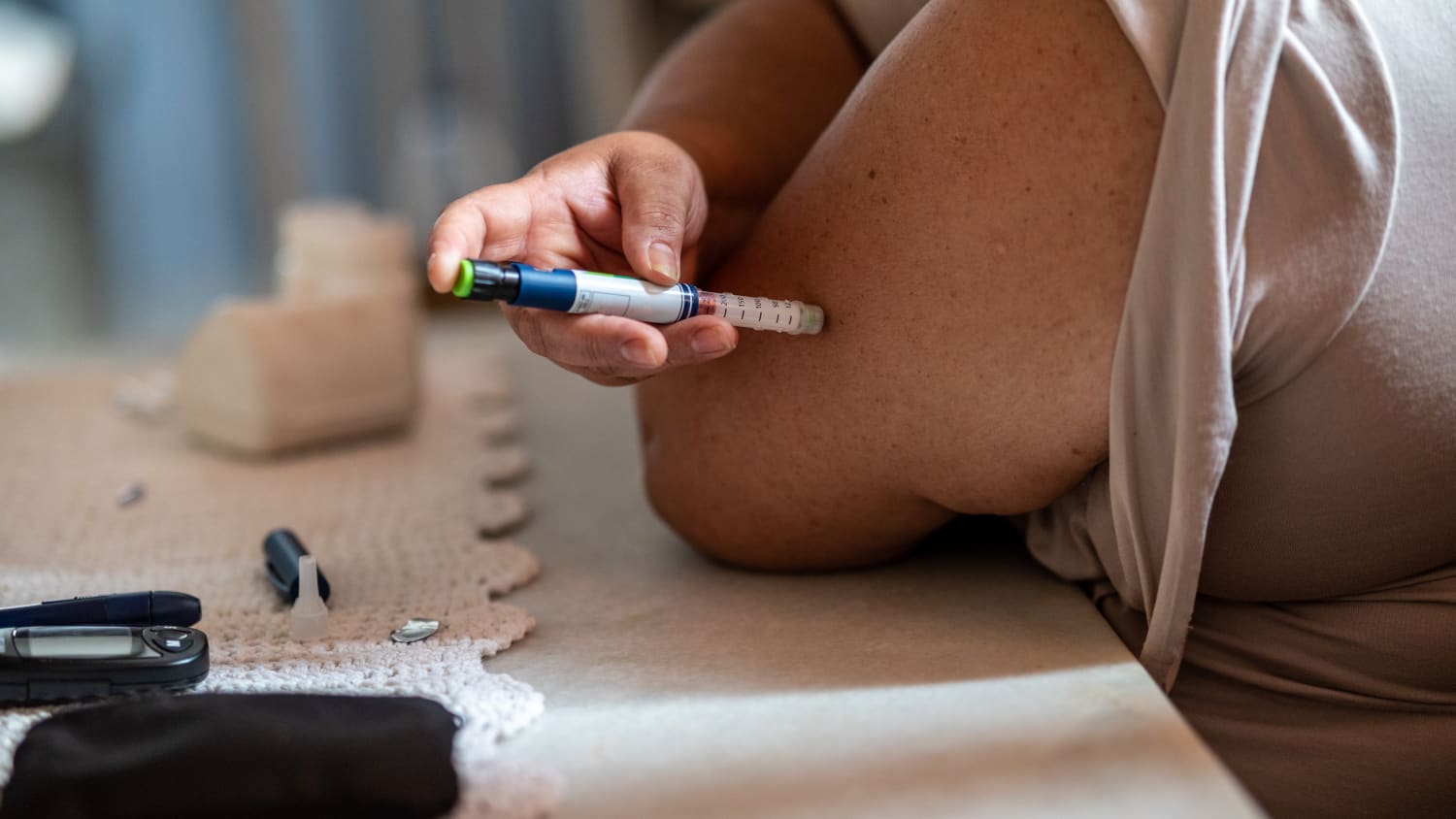 person injecting diabetes medication