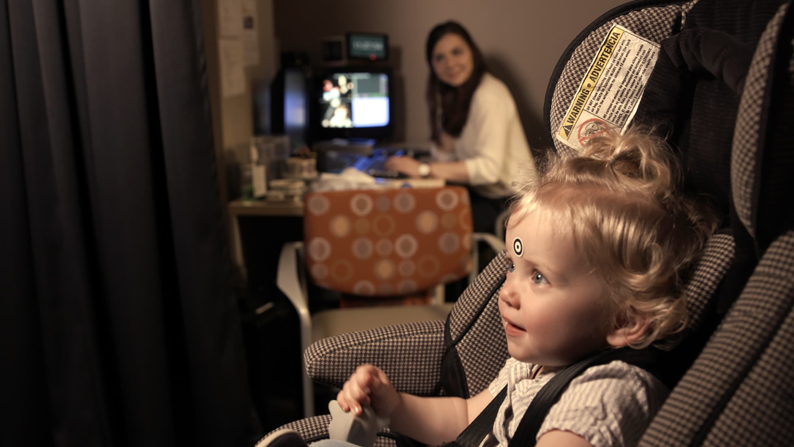A baby undergoes eye-tracking screening for early detection of autism.